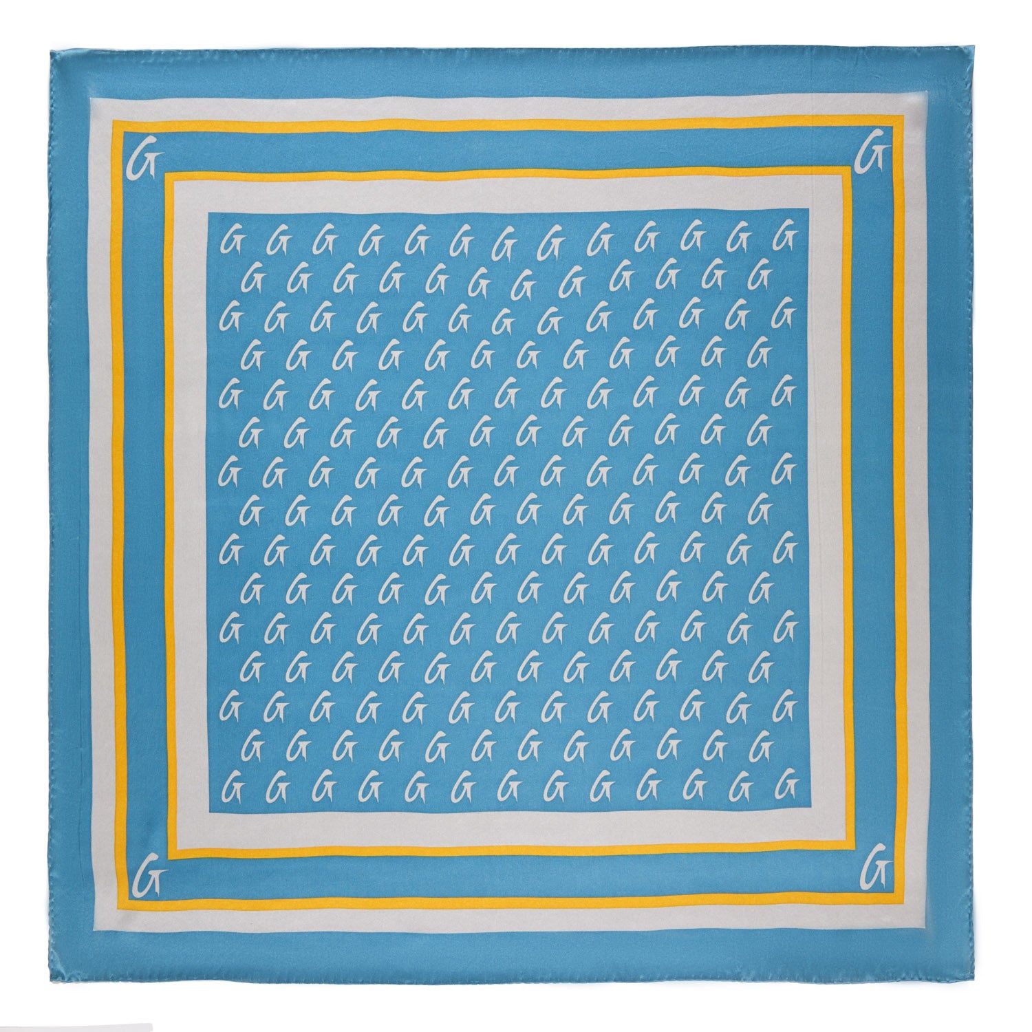 Medium blue silk scarf with a gold monogram pattern and border, featuring white "G" initials on a stylish design.