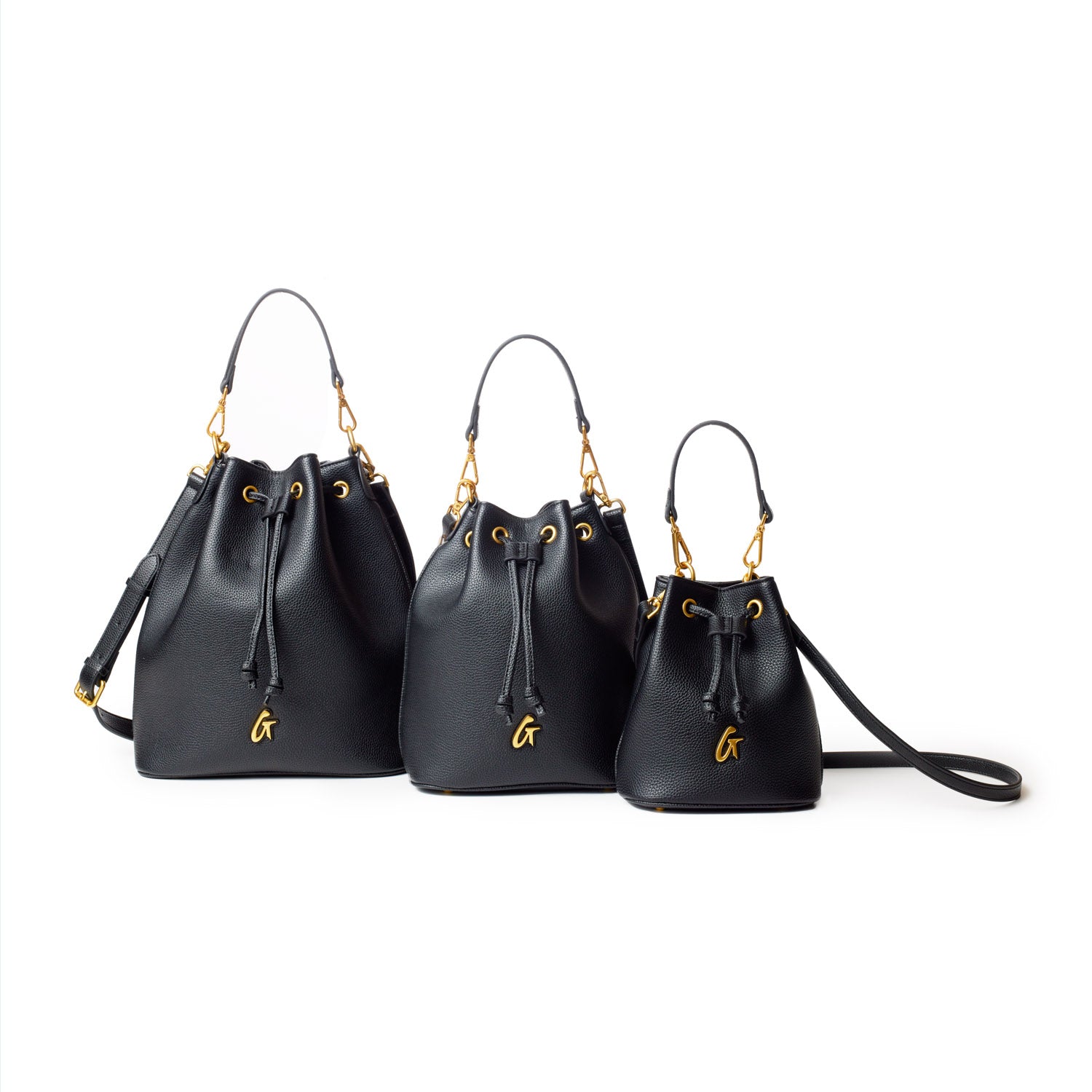 Large black pebble bucket bags with gold hardware, drawstring closure, and adjustable straps, shown in three sizes.
