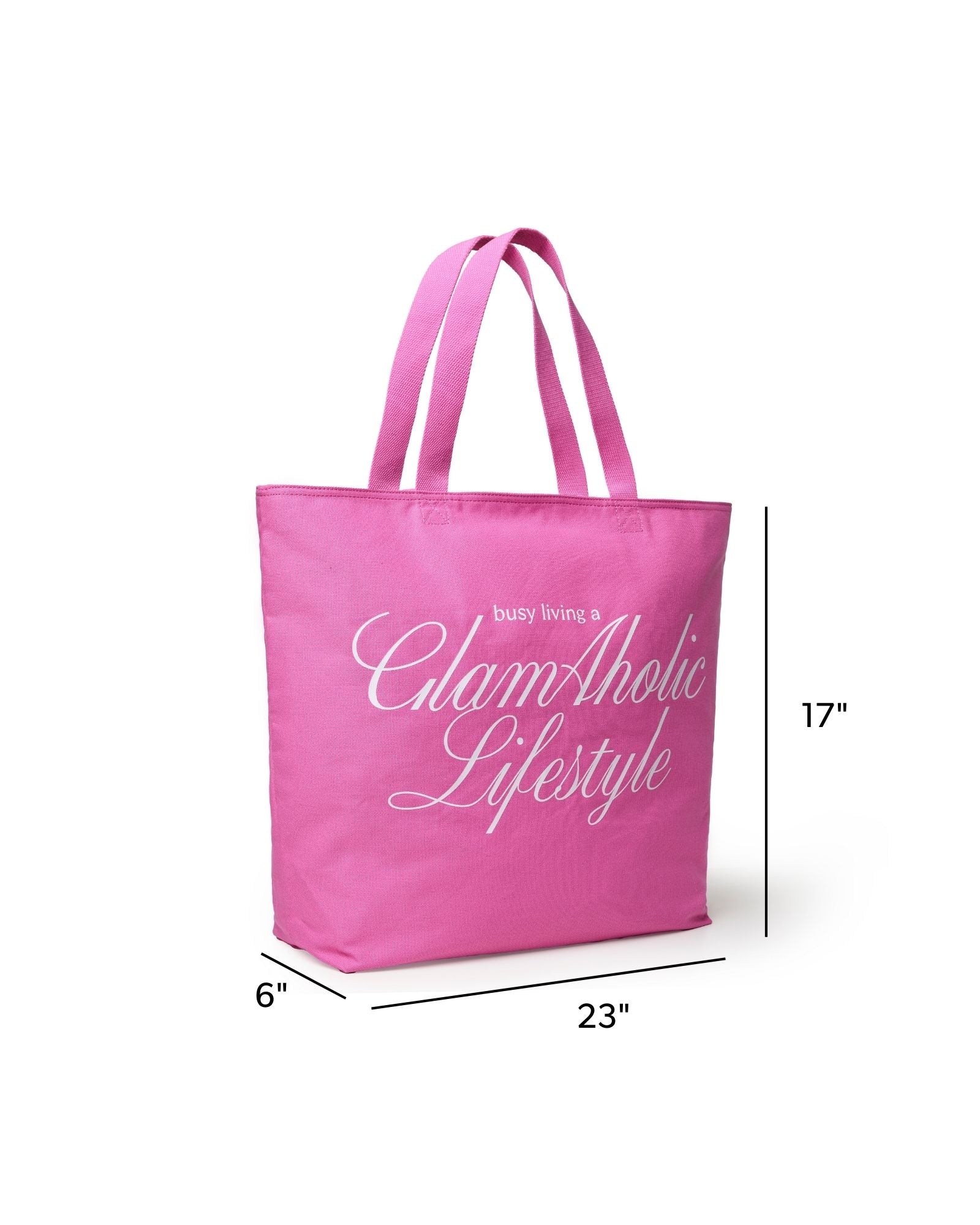 Hot pink canvas tote bag with "busy living a GlamAholic Lifestyle" printed in white, measuring 23 inches wide and 17 inches tall.