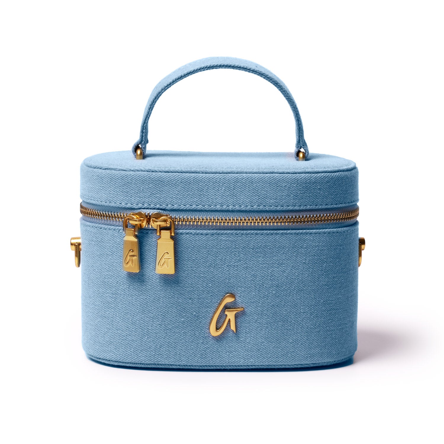 Light blue denim vanity bag with gold accents, dual zipper closure, top handle, and a gold "G" logo on the front.