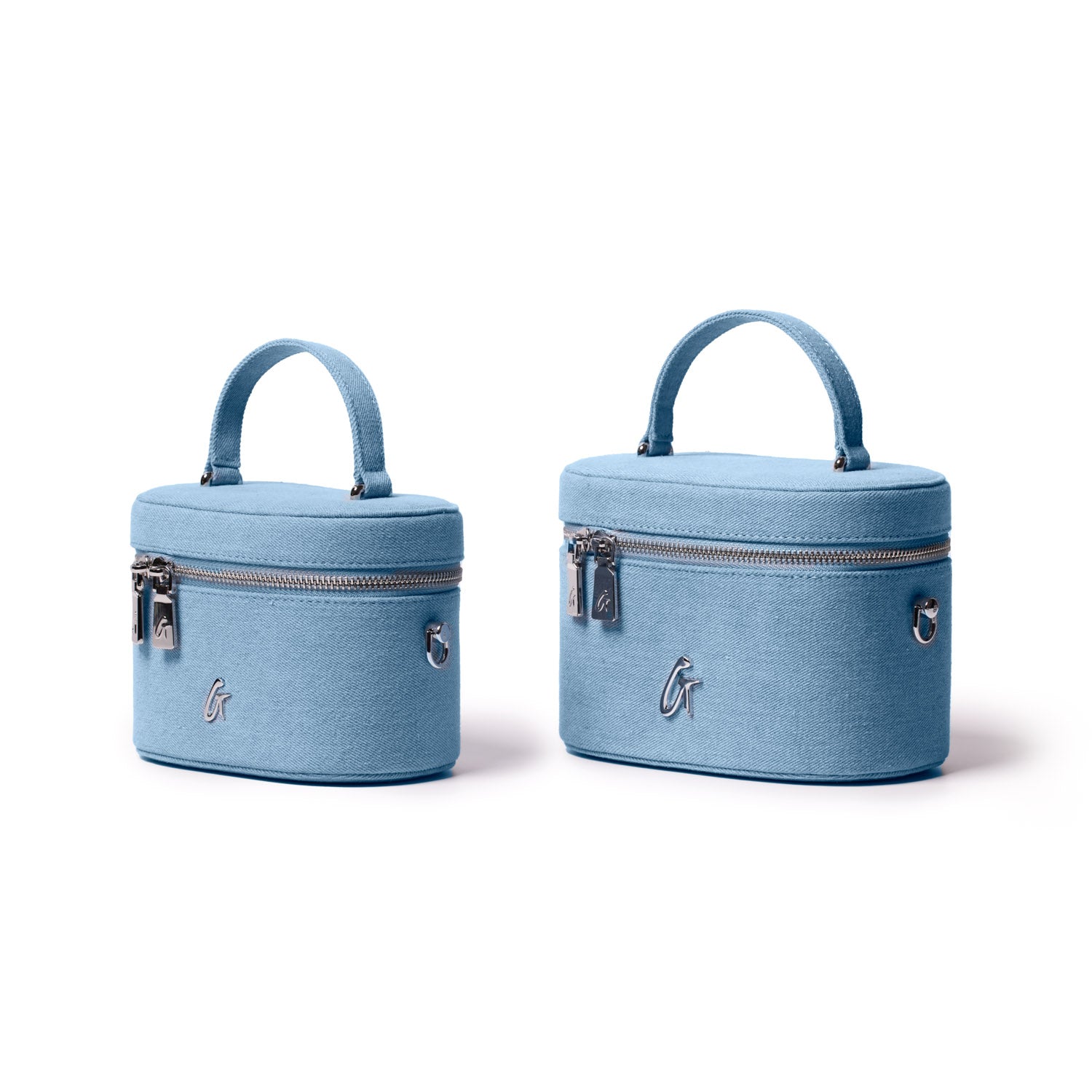 Mini denim silver vanity bags with top handles, silver zippers, and a stylish "G" logo on a white background.
