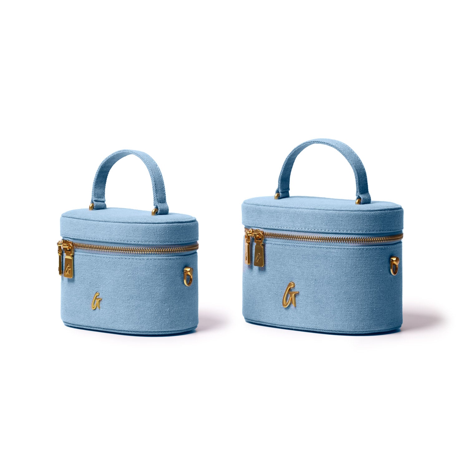 Mini denim vanity bags with gold zippers, handle, and a gold "G" logo, available in two sizes, light blue color.