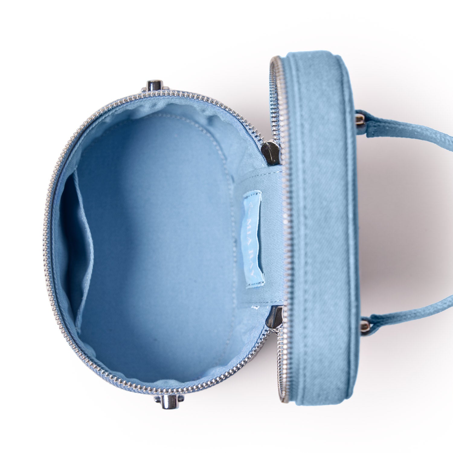 Open blue denim silver vanity bag with spacious interior, zipper closure, and handle for easy carrying.