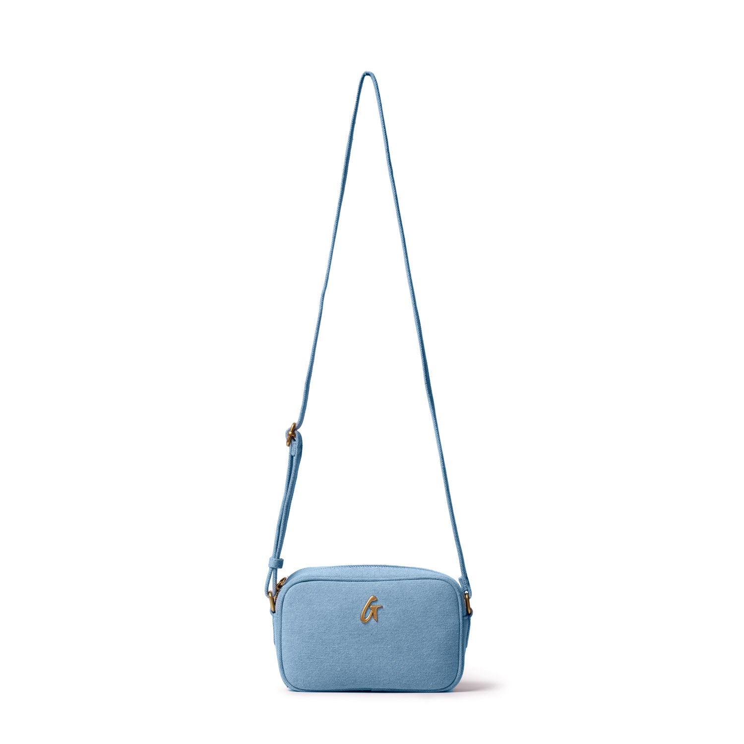 Mini denim gold camera bag with a gold logo, adjustable strap, and compact rectangular design on a white background.
