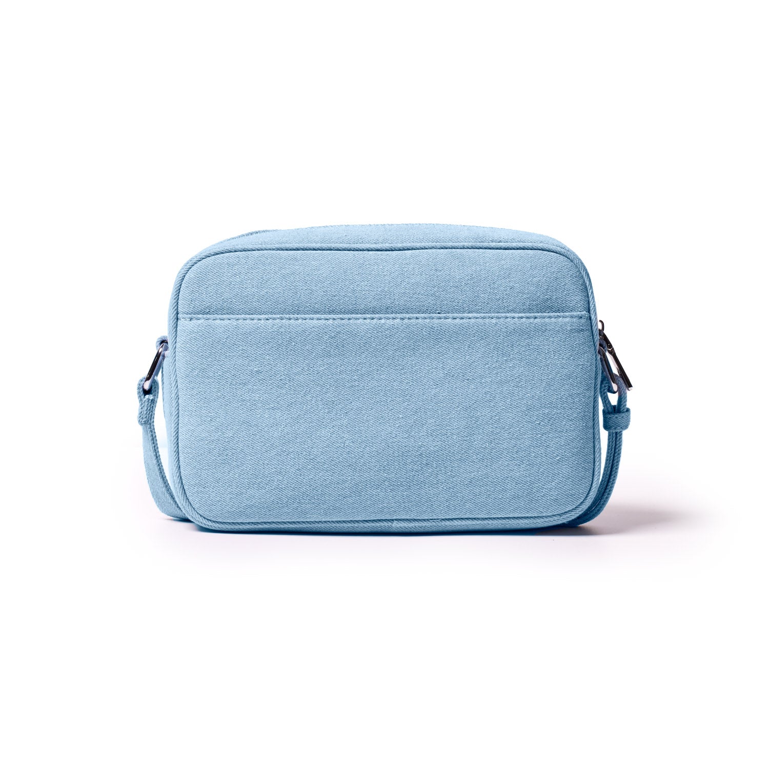 Light blue denim camera bag with a front pocket, adjustable strap, and silver hardware on a white background.