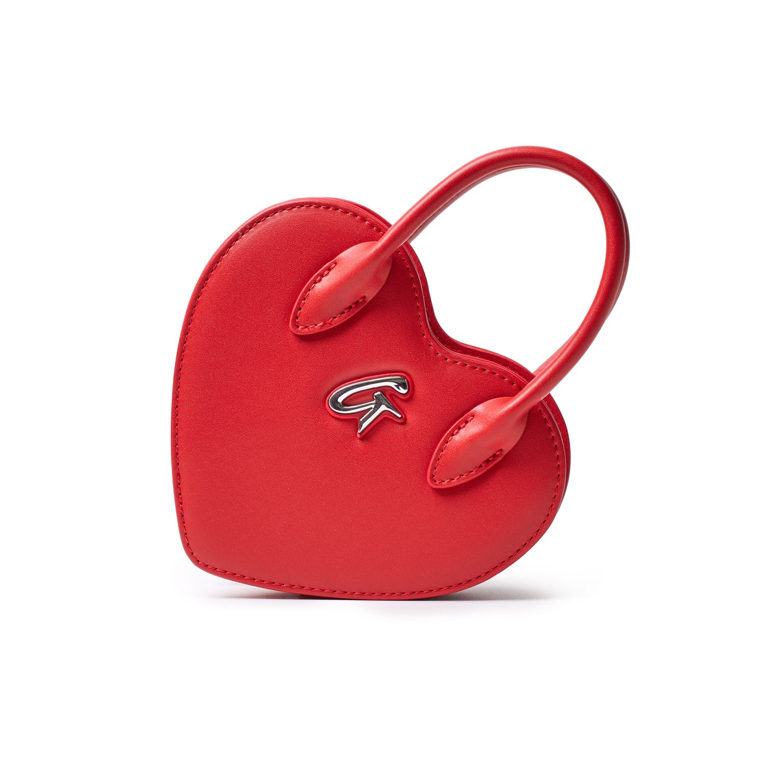 Small red heart-shaped bag with a silver logo, featuring two curved handles and a smooth leather finish.
