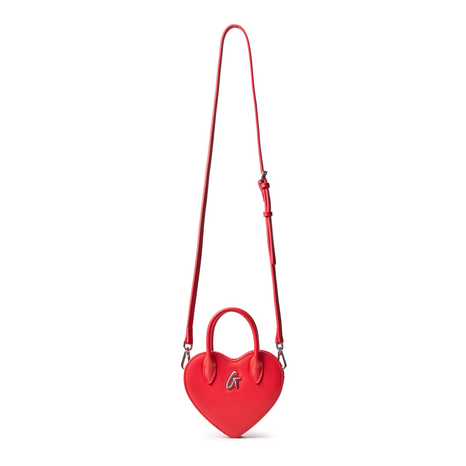 Red heart-shaped mini bag with a top handle, silver "G" logo, and adjustable shoulder strap.