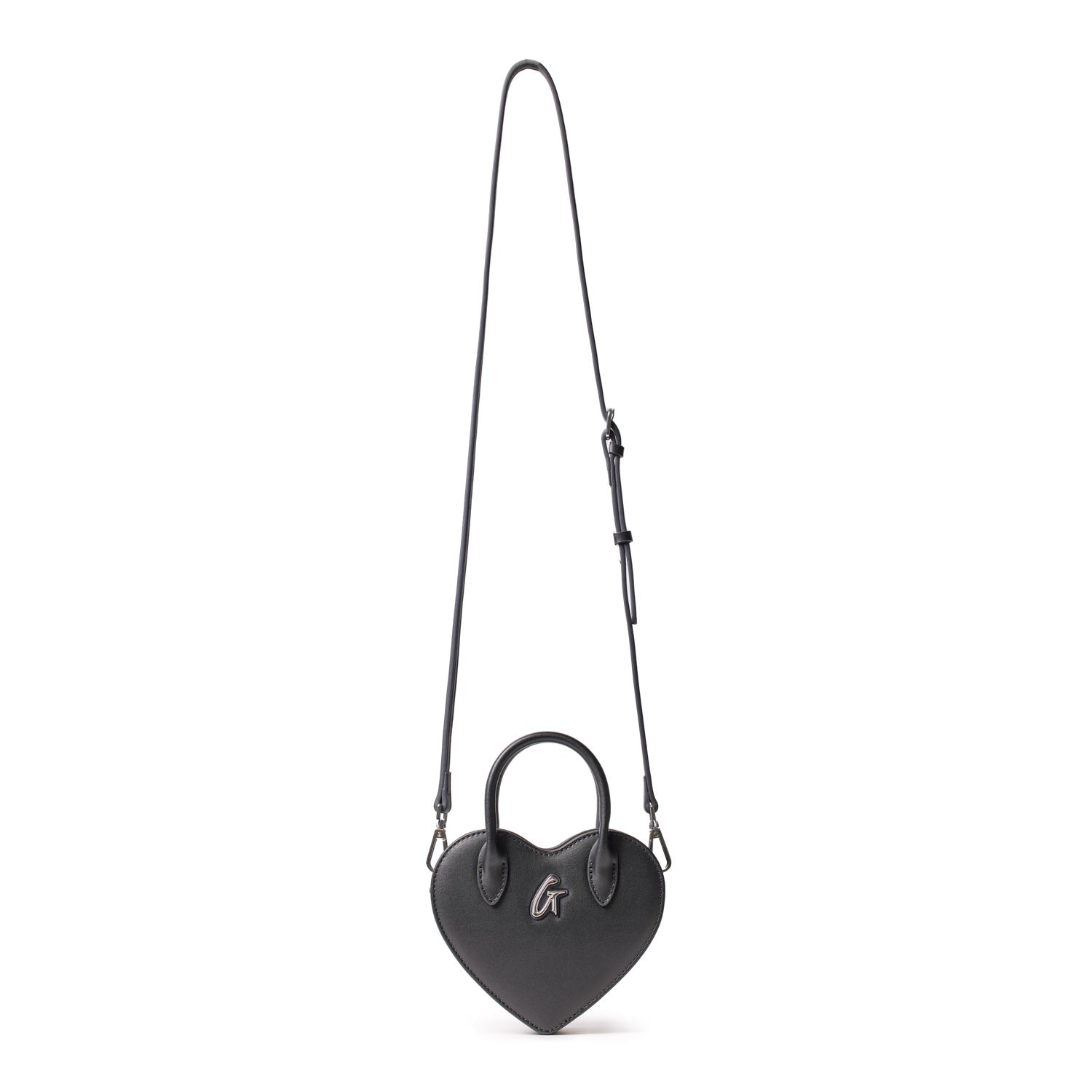 Small black heart-shaped bag with a top handle, silver logo, and adjustable shoulder strap on a white background.