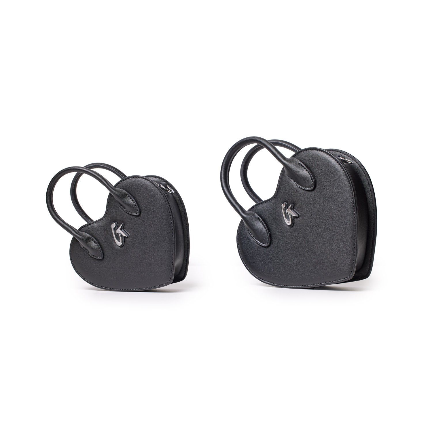 Two black heart-shaped mini bags with double handles, silver logo detail, and zipper closure, shown against a white background.