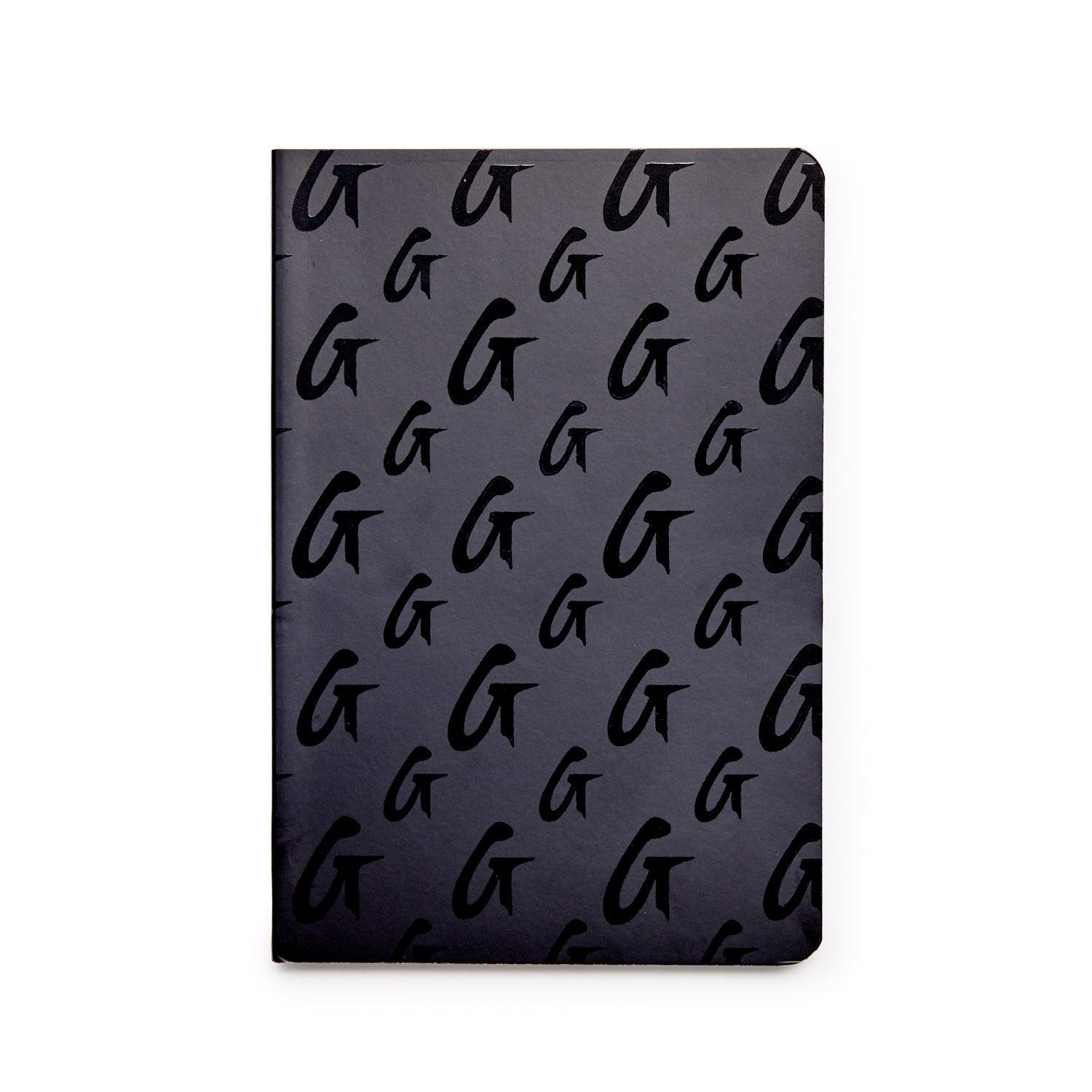 Black monogram notebook with a repeating "G" pattern on the cover.