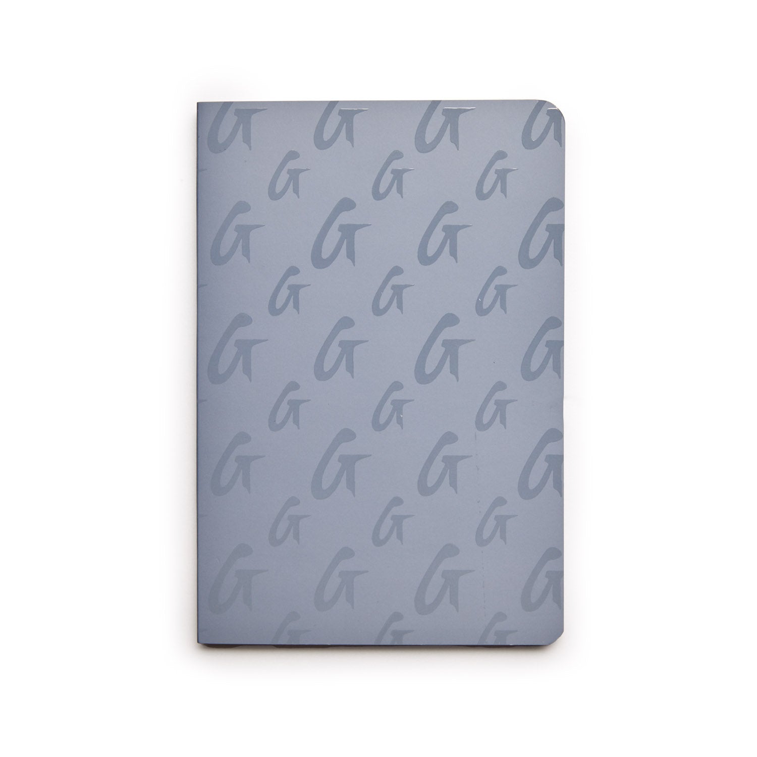 Gray monogram notebook with a repeating "G" pattern on the cover, featuring rounded corners and a sleek, modern design.