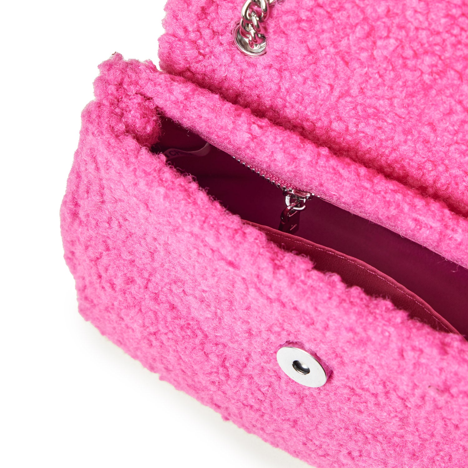 Mini teddy flap bag in hot pink with textured fuzzy exterior, silver chain detail, and interior zip pocket.