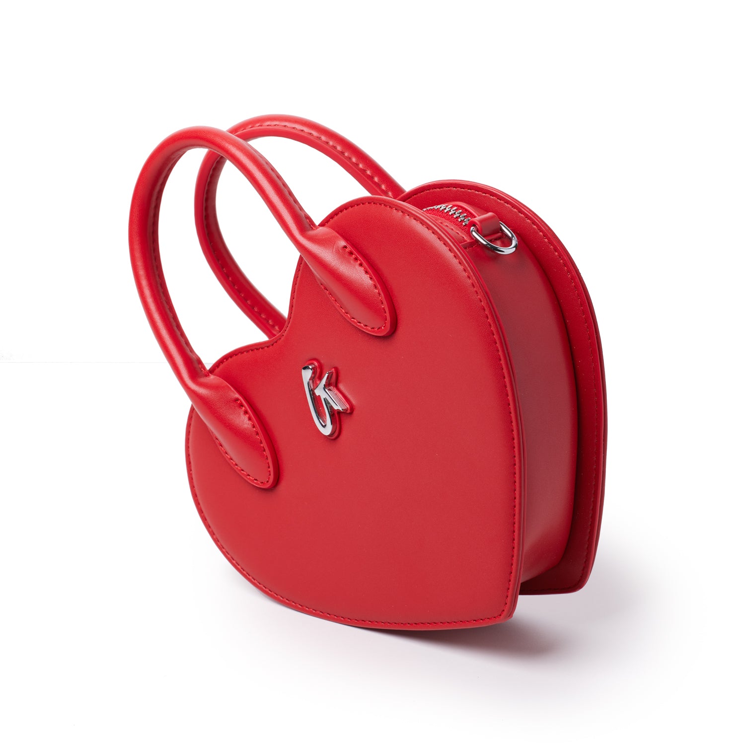 Red heart-shaped bag with top handles and a silver logo, featuring a zipper closure on a white background.