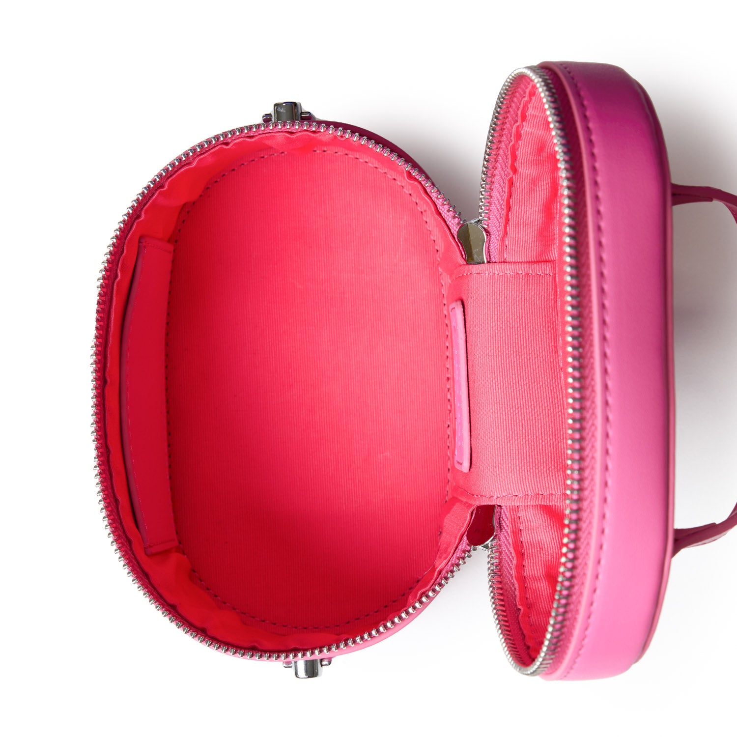 Mini smooth silver vanity bag in hot pink with a sleek, shiny exterior and spacious interior for cosmetics and accessories.
