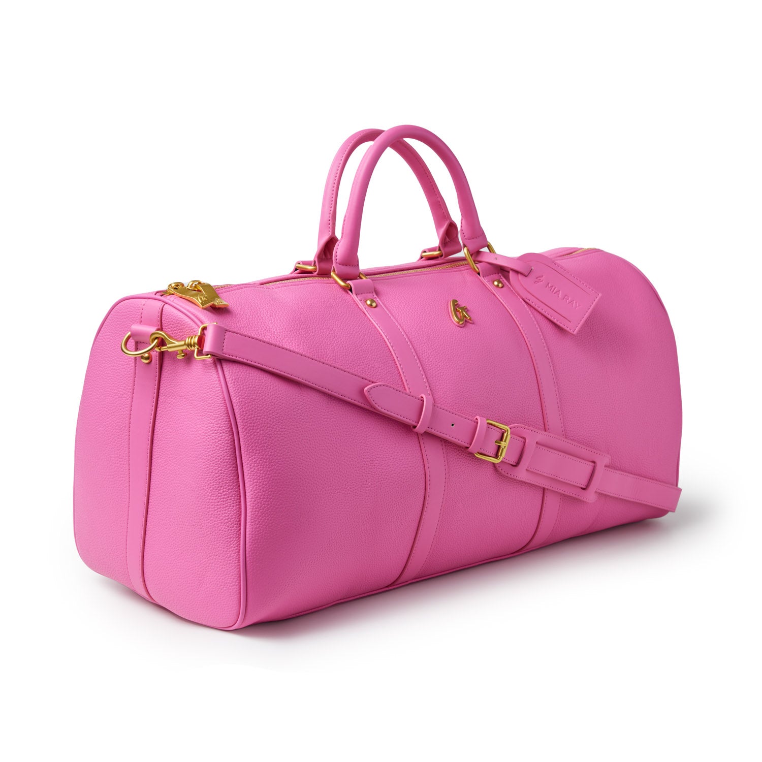 Pink Pebble Duffle Bag with gold hardware, dual handles, adjustable strap, and a luggage tag for travel.
