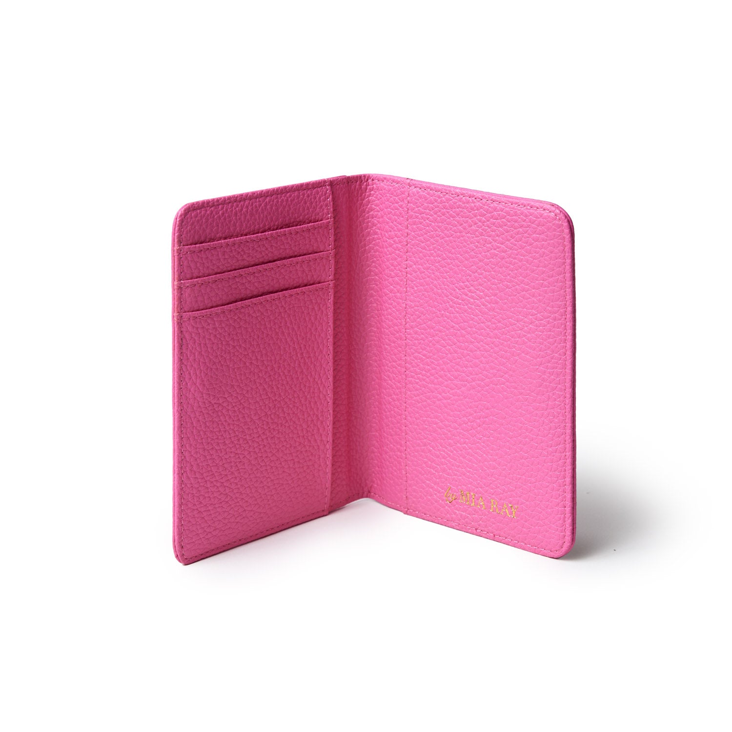 Open pink pebble leather passport holder with card slots, featuring gold "by JULIA RAY" branding inside.