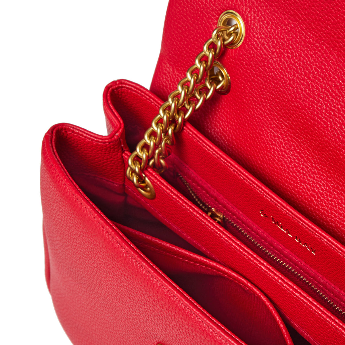 Close-up of a red medium pebble flap bag with gold chain strap and interior zip pocket, showcasing textured leather and detailed craftsmanship.