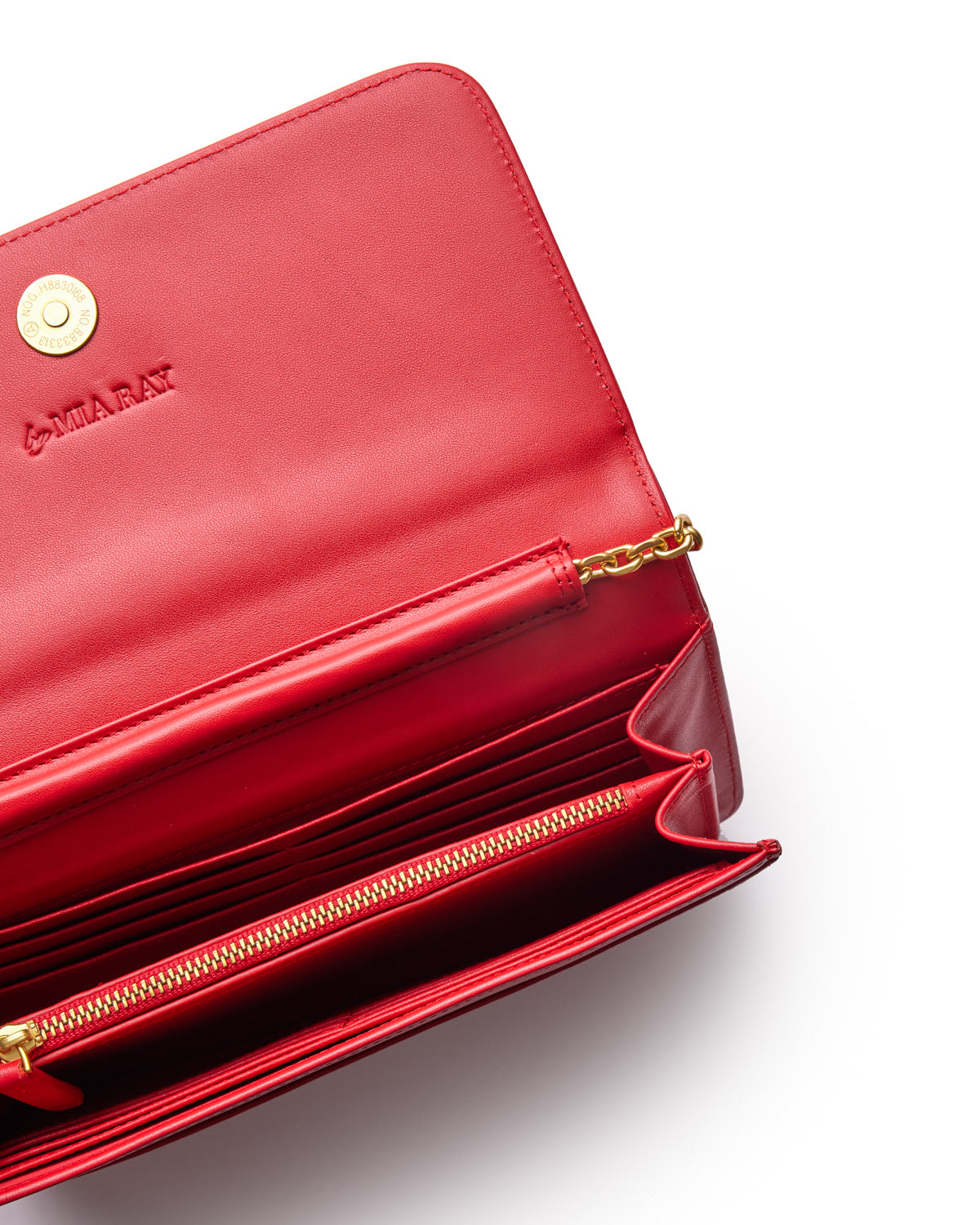 Red Monogram Gold WOC wallet with gold chain detail, multiple card slots, zippered compartment, and embossed logo.