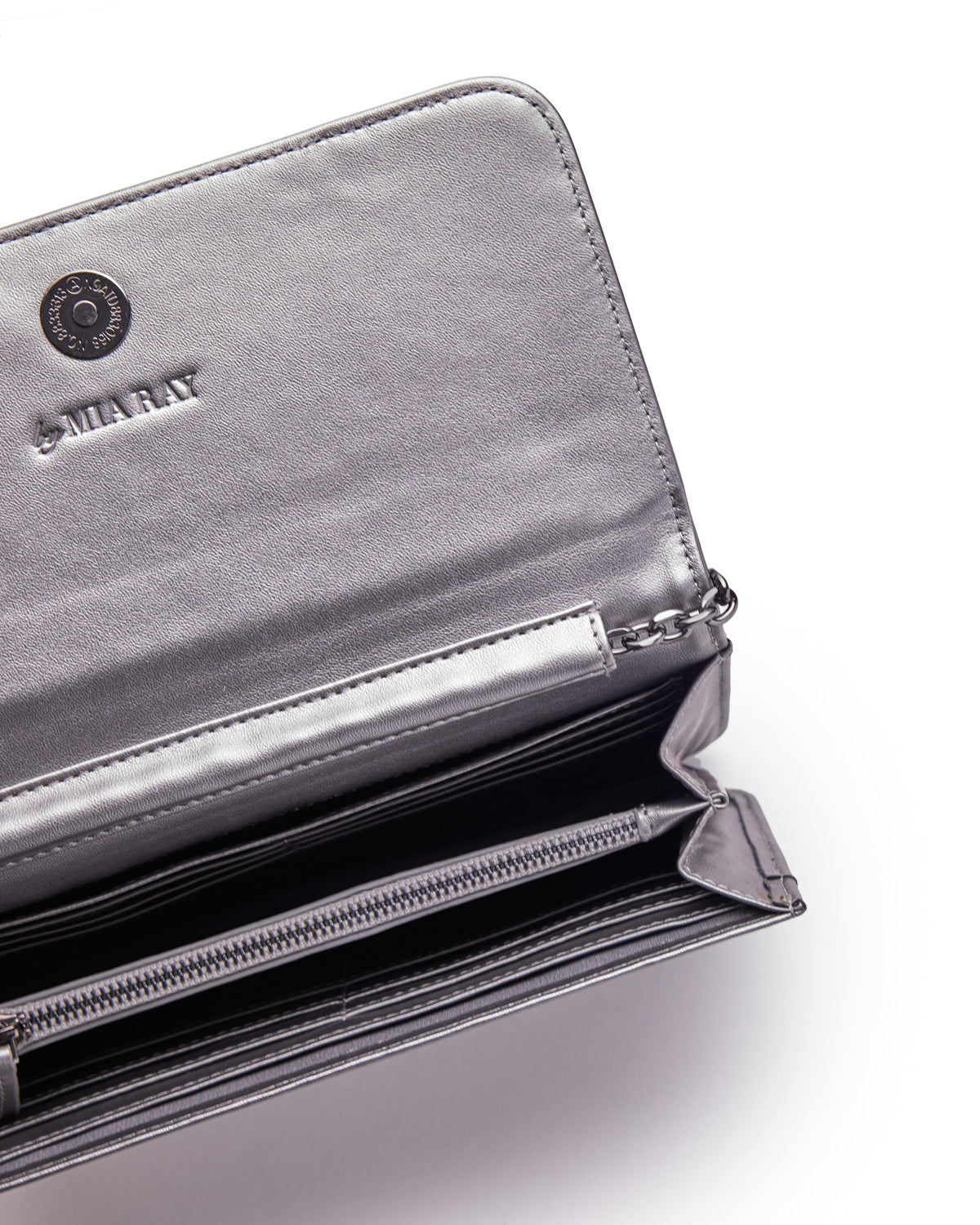 Open metallic gunmetal gray wallet with multiple card slots, a zippered compartment, and embossed "MARNAY" logo inside.