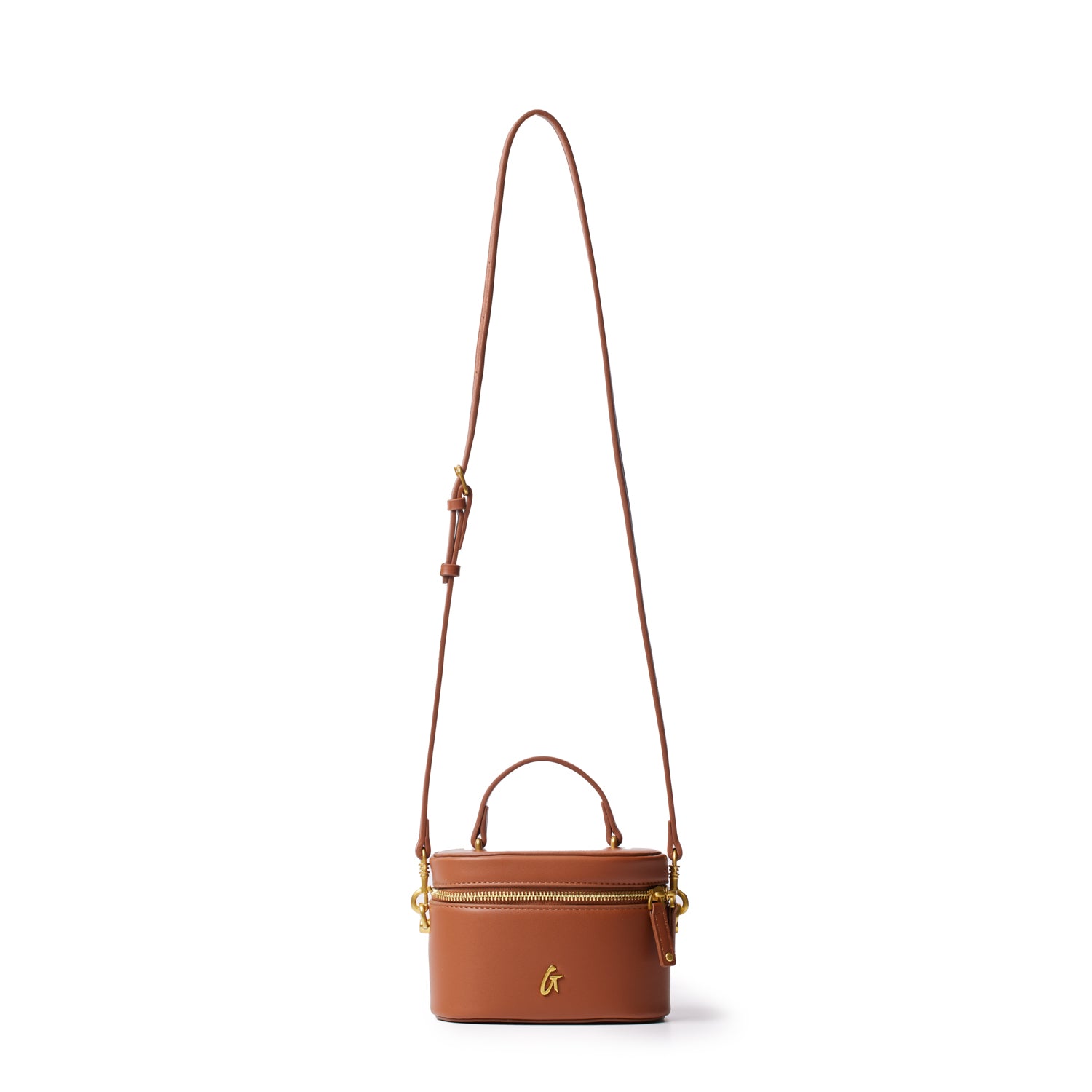 Mini smooth gold vanity bag in brown with a top handle, gold zipper, and adjustable shoulder strap.