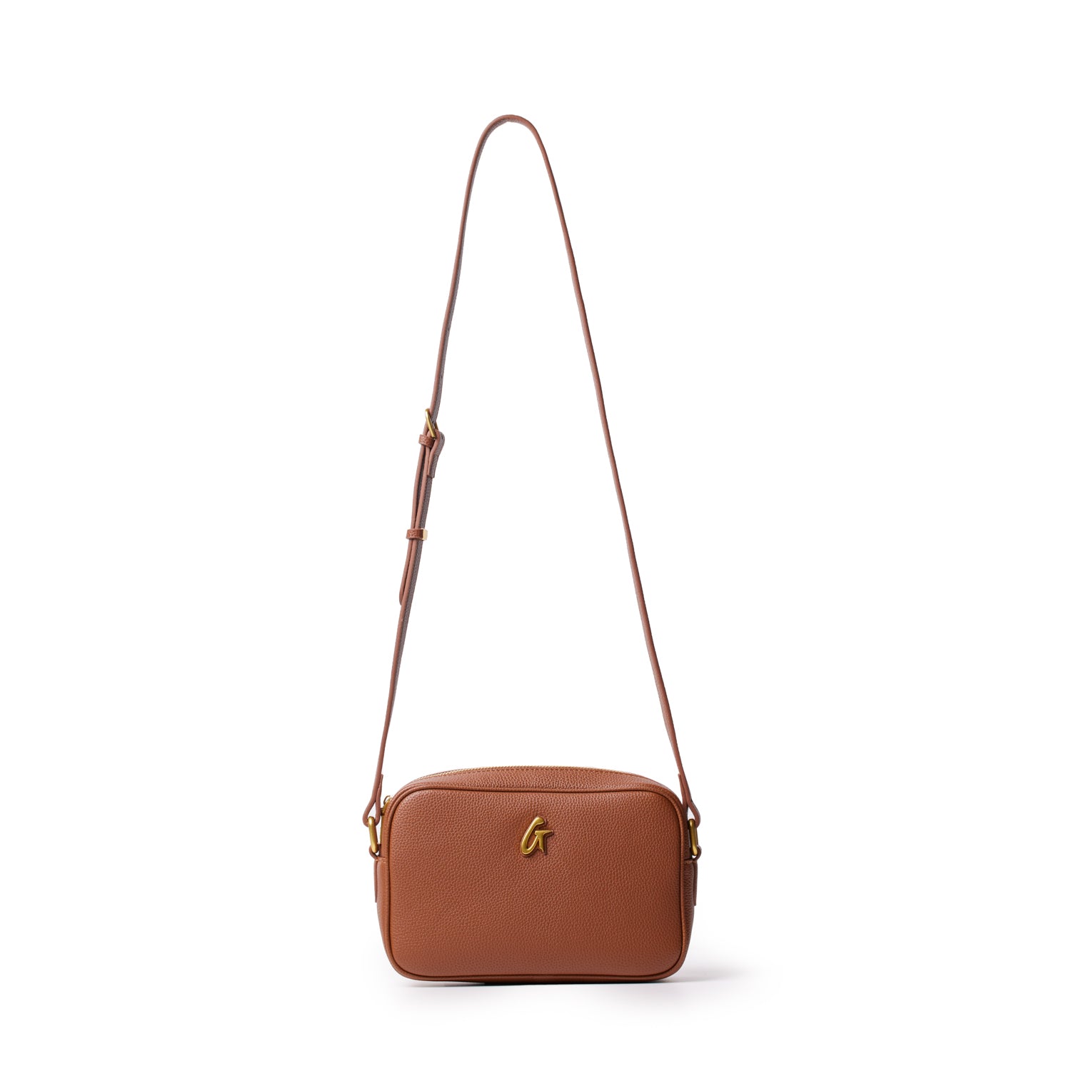 Brown leather pebble camera bag with adjustable strap and gold logo detail on front.