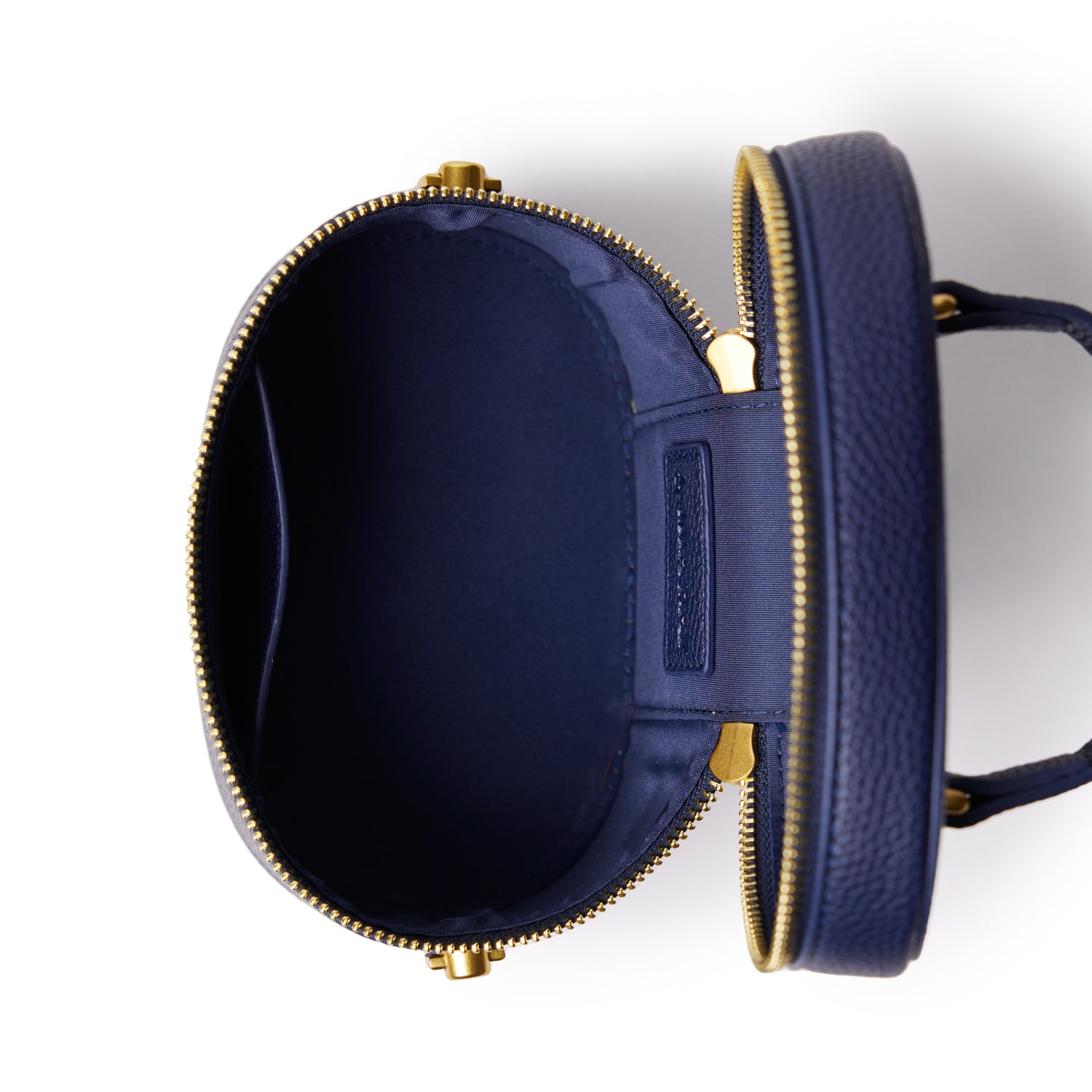 Open navy mini pebble vanity bag with gold zipper, showing spacious interior and organized compartments.