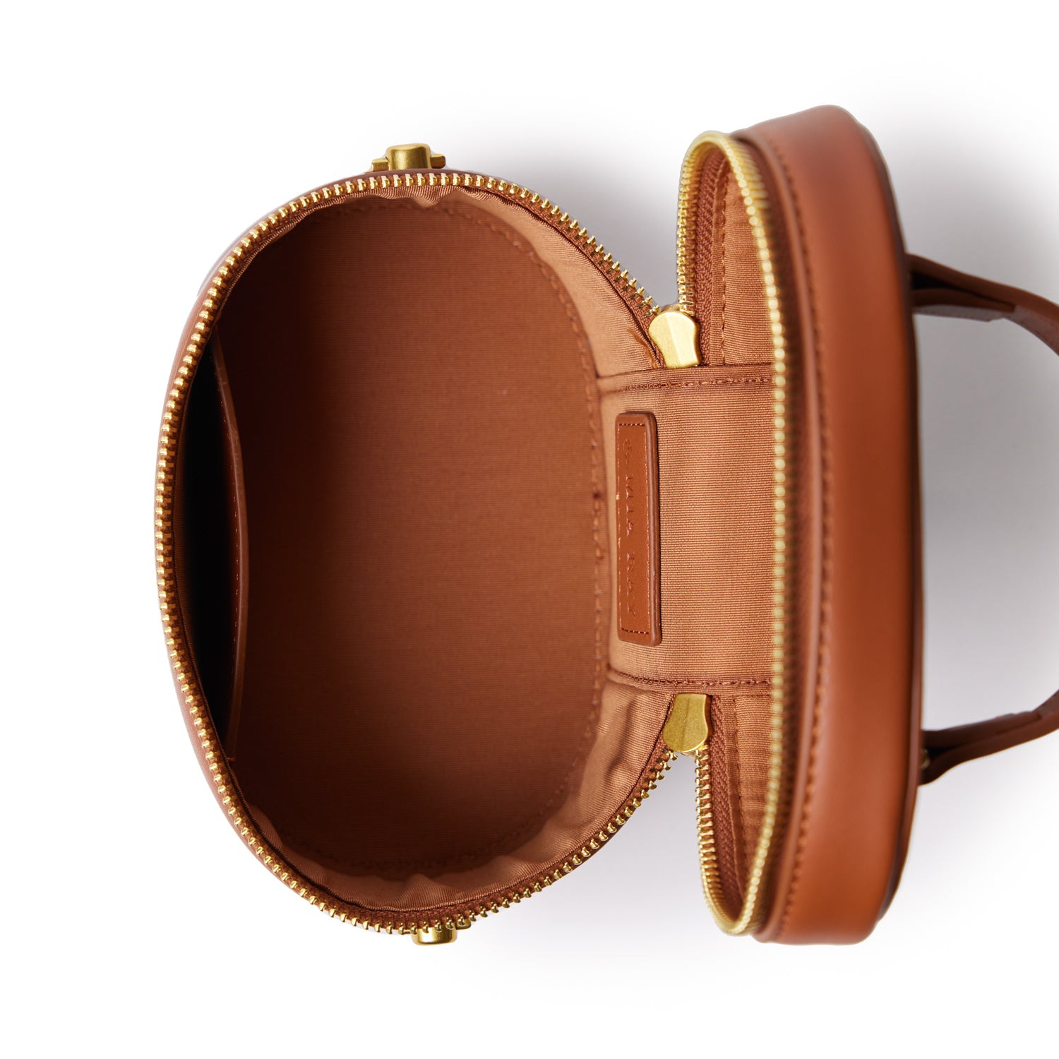 Open brown mini vanity bag with gold zipper, smooth finish, and spacious interior for makeup or accessories.