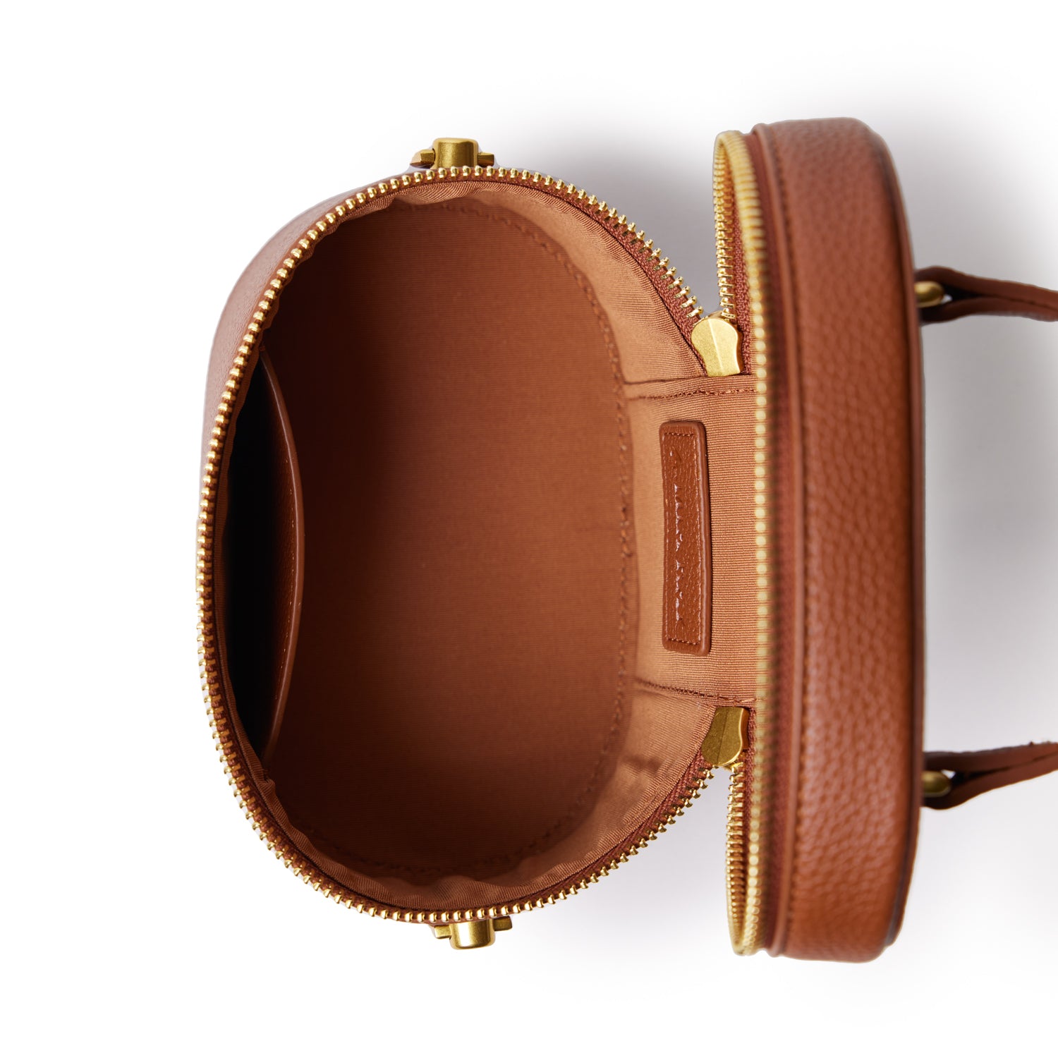 Open brown mini pebble vanity bag with gold zipper, interior pocket, and label, designed for cosmetics and small essentials.