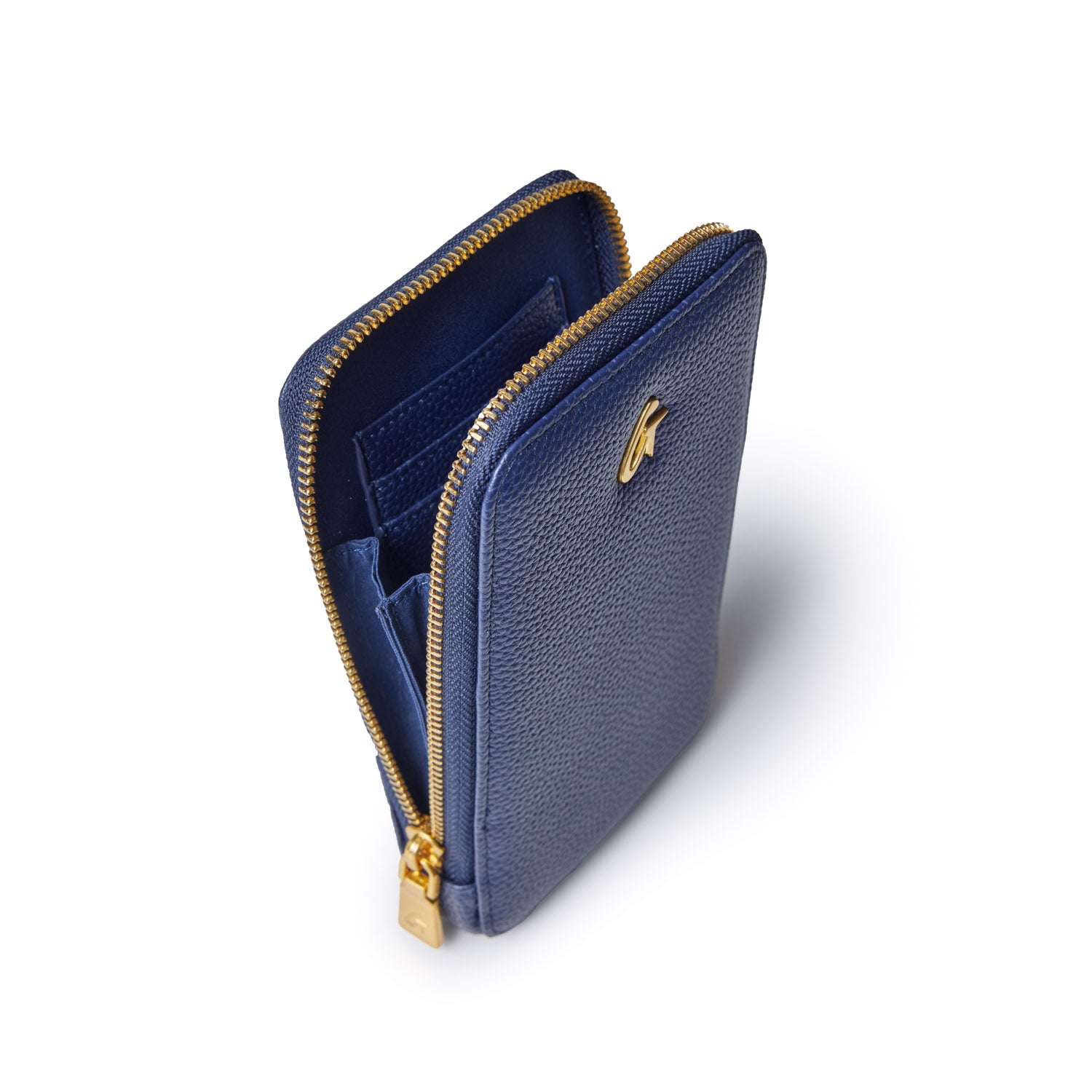 Navy Pebble Phone Crossbody bag with gold zipper and interior card slots, shown from an angled top view.