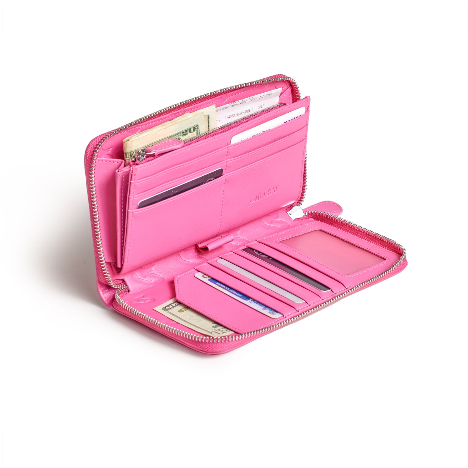 Open pink wallet with multiple card slots, cash compartment, and zippered coin pocket, featuring a large signature logo.