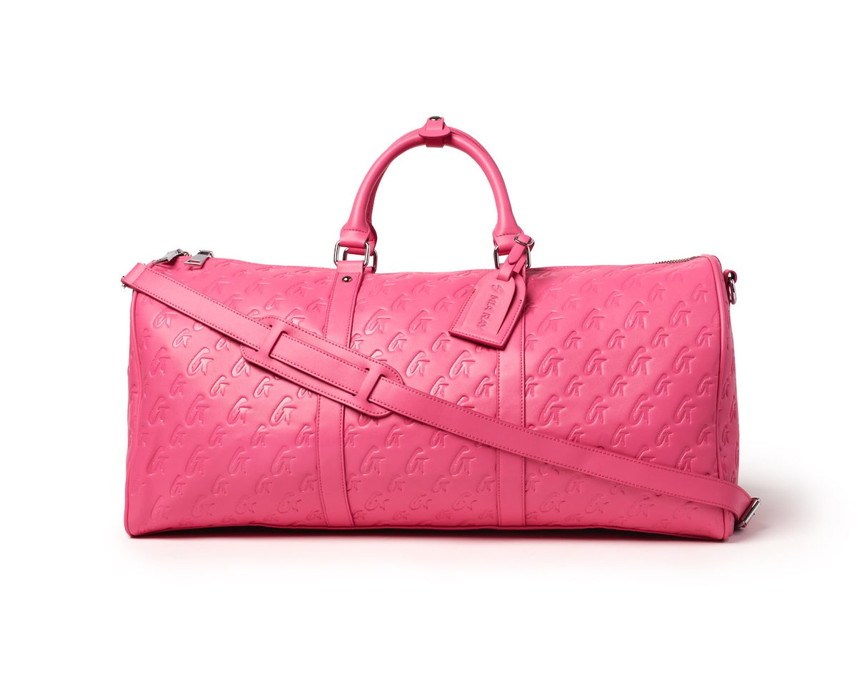 Hot pink monogram travel set featuring a spacious duffel bag with stylish handles and adjustable strap.