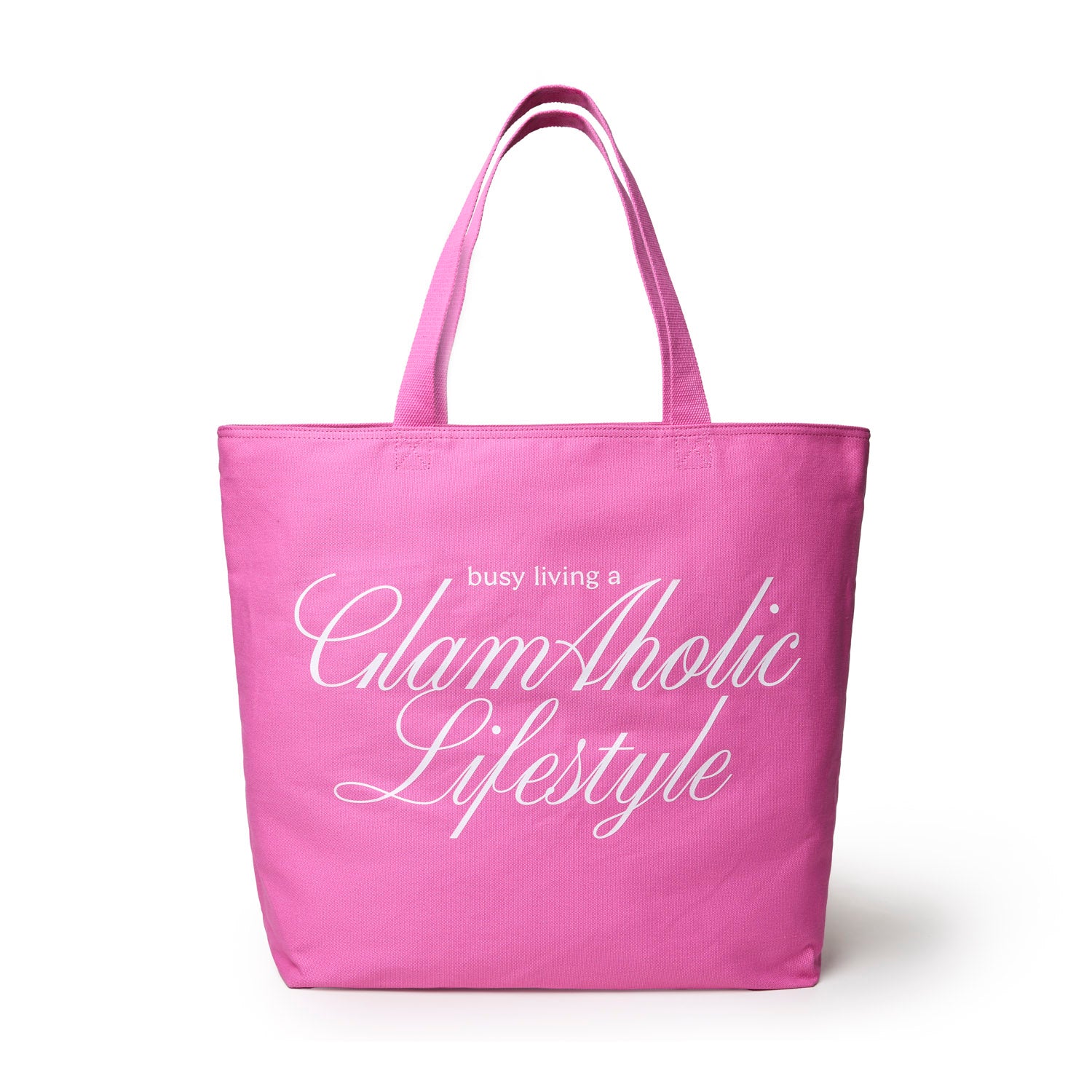 Hot pink canvas tote bag featuring the phrase "busy living a Glam-Aholic Lifestyle" in elegant white lettering.