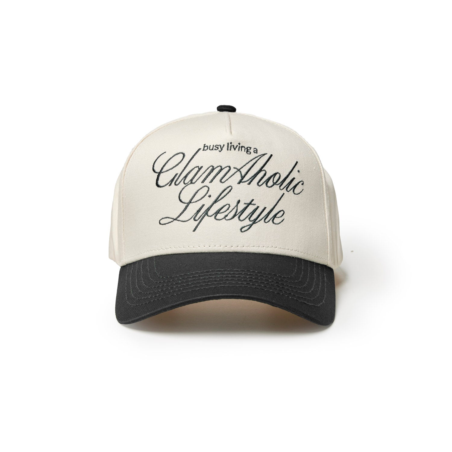 Black trucker hat with cream front featuring the text "busy living a GlamAholic Lifestyle" in stylish script.