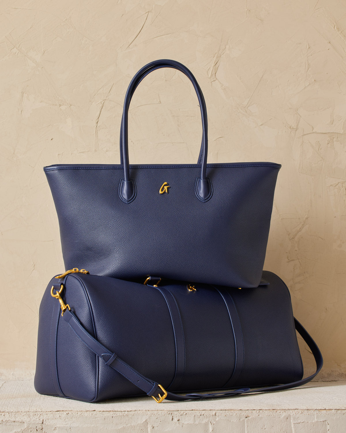 Elegant navy blue handbags with gold accents, featuring textured faux leather for a luxurious, designer-inspired look.