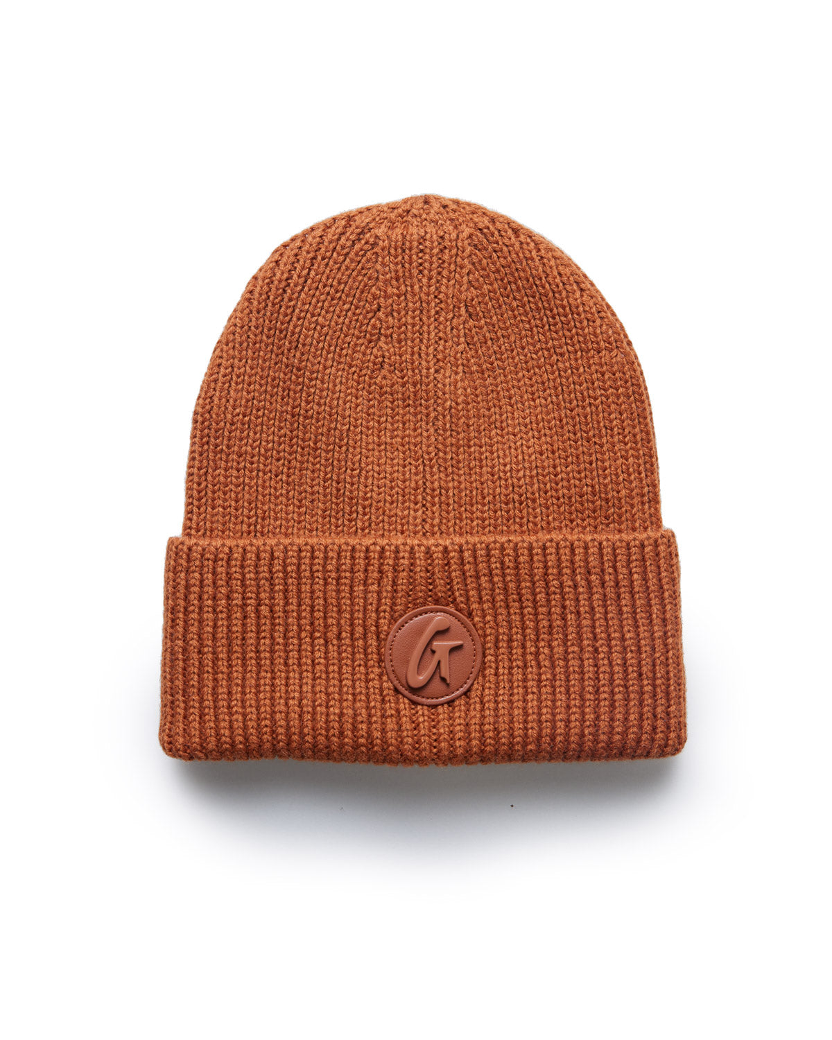 Brown classic knit beanie with a folded cuff and a round leather logo patch on the front.