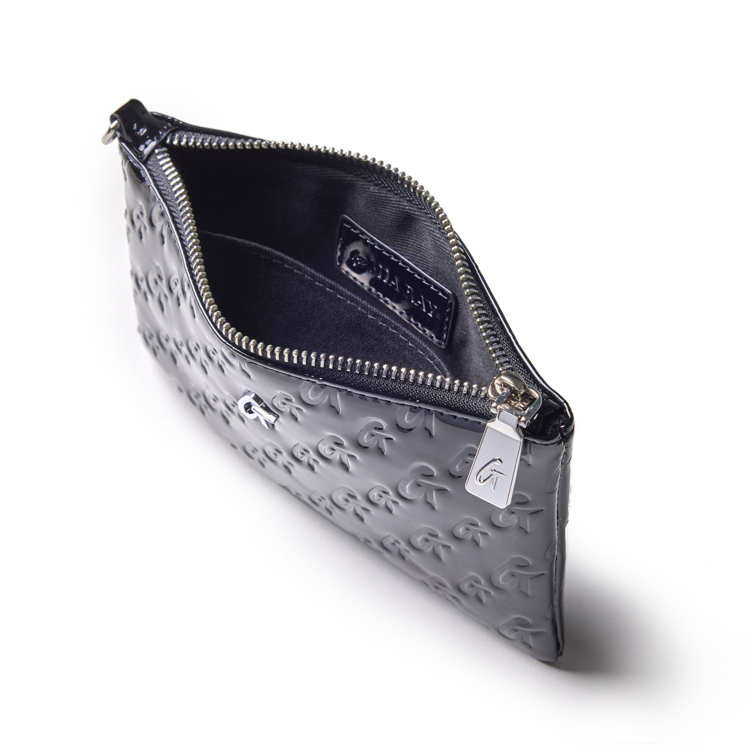 Mini monogram silver wristlet in mirror black with embossed G pattern, silver zipper, and interior pocket.
