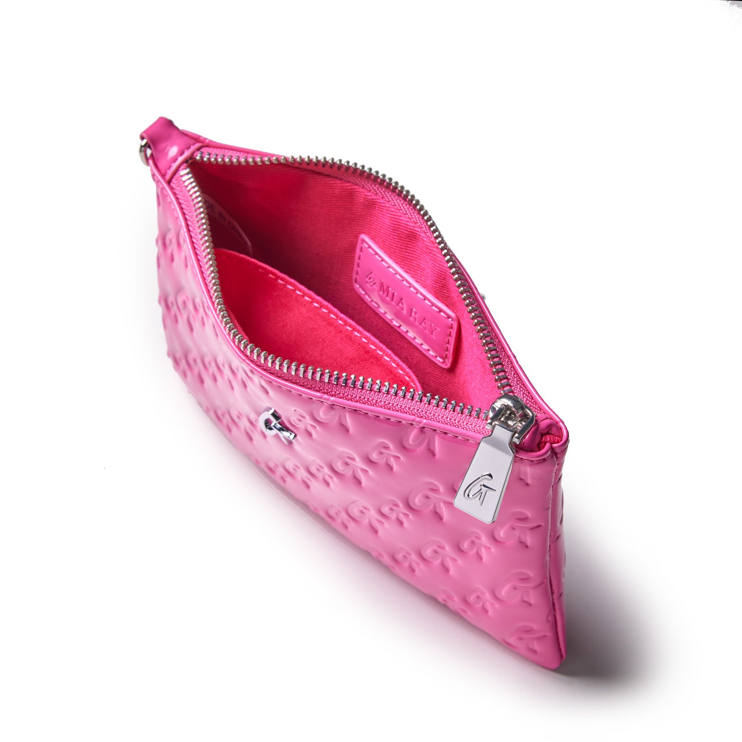 Mini Monogram silver wristlet in mirror hot pink with embossed logo pattern, silver zipper, and interior card slot.