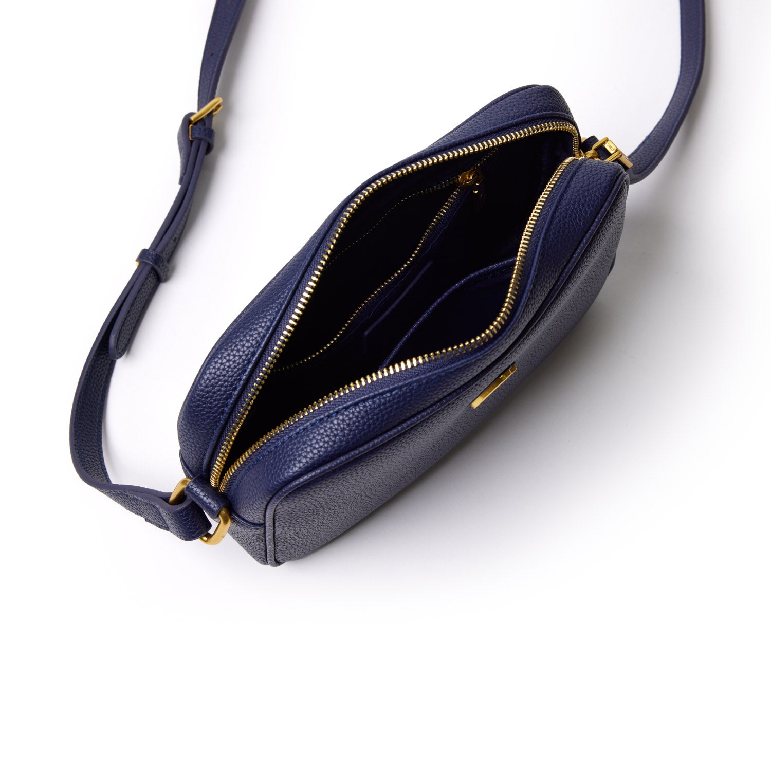 Mini pebble navy camera bag with gold zipper, open interior showing multiple compartments and adjustable strap.