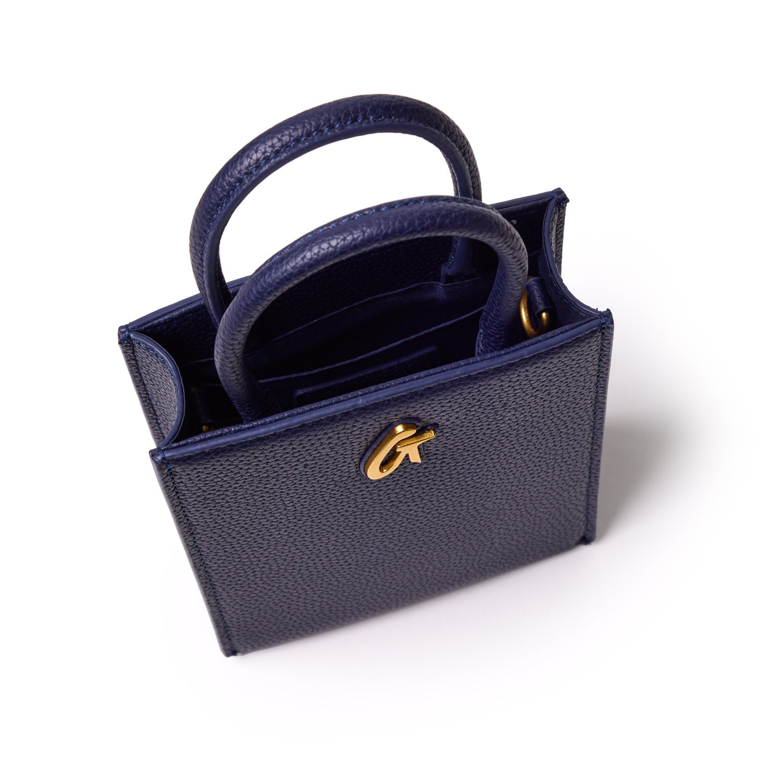 Mini navy pebble leather tote bag with gold hardware, dual handles, and interior card slots.