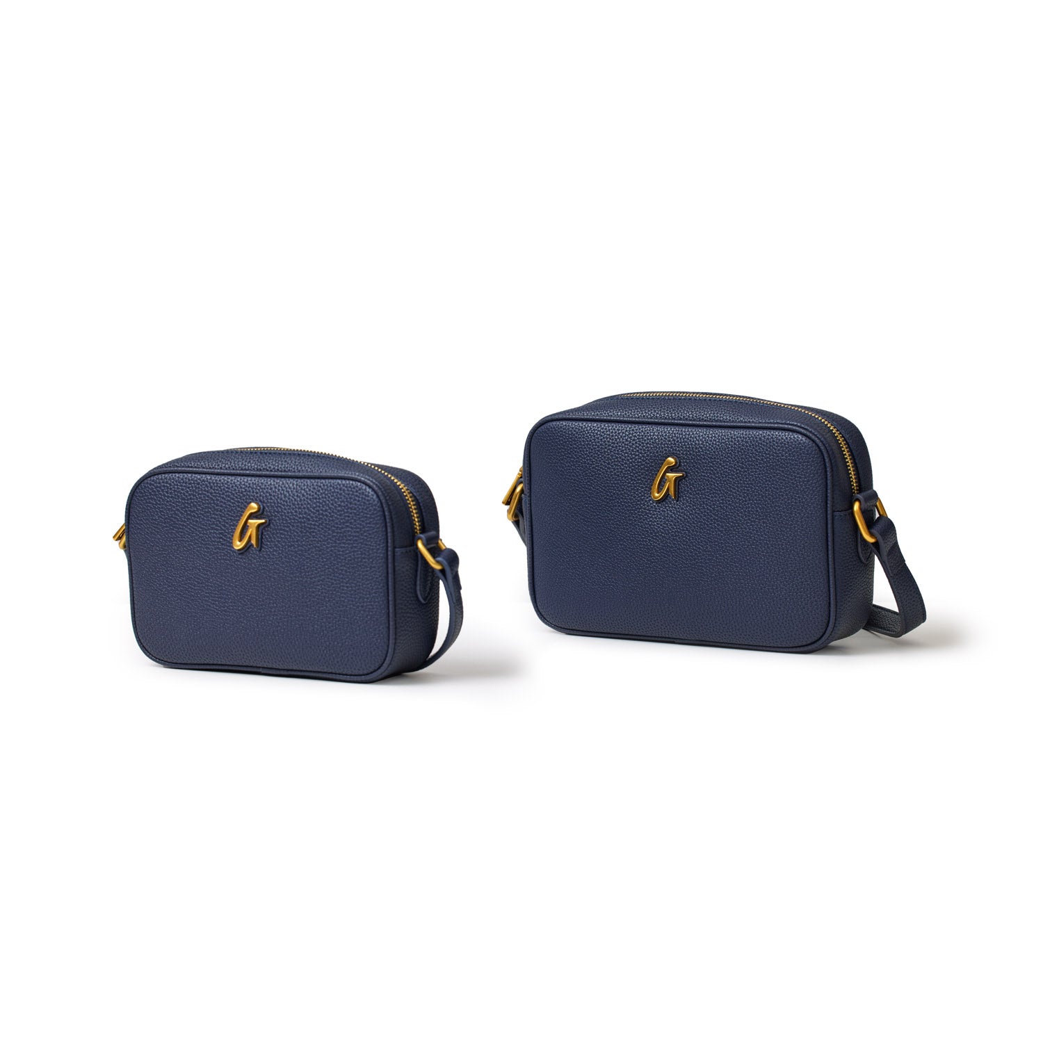 Two navy blue pebble leather camera bags with gold zippers and a gold "G" logo, shown in small and medium sizes.