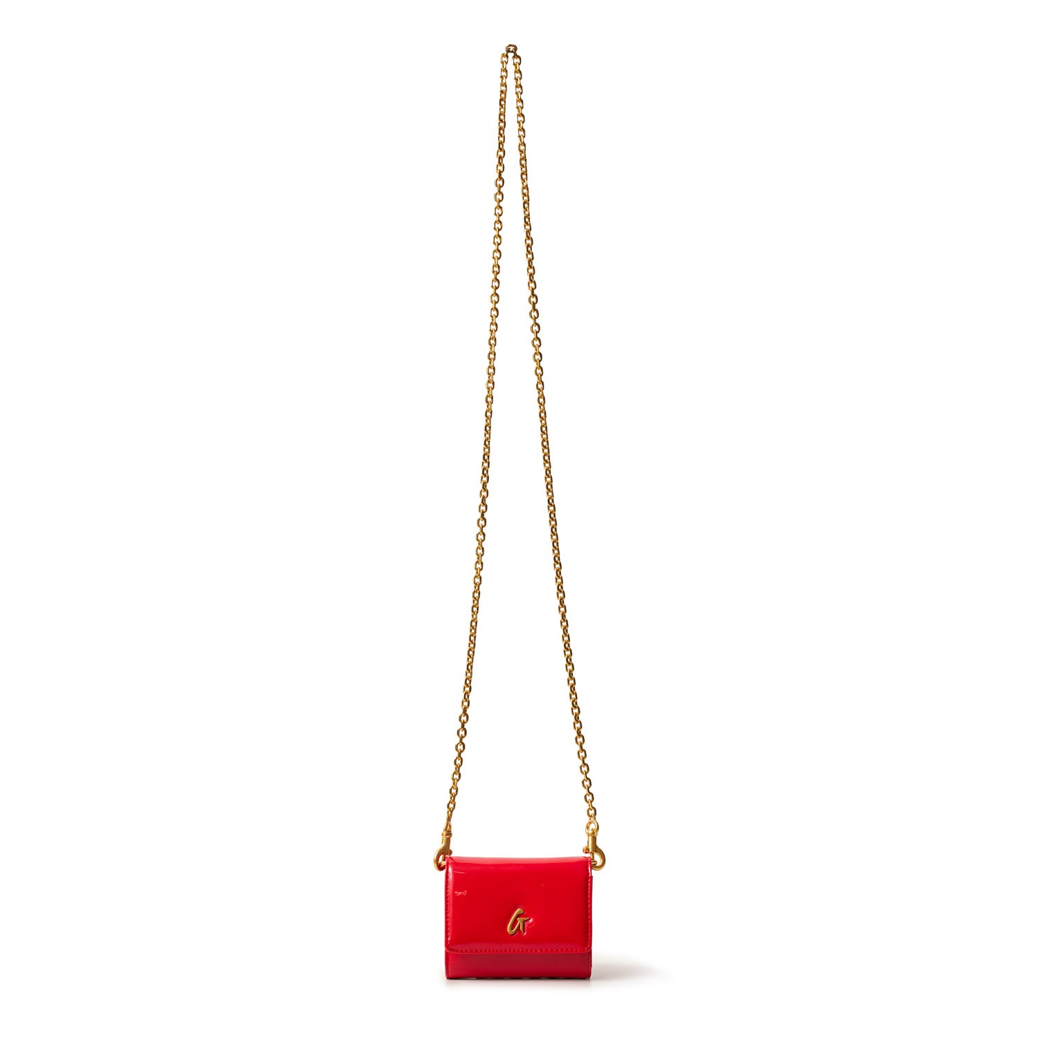 Red compact mirror with a gold chain and "G" logo, designed as a stylish accessory for on-the-go use.