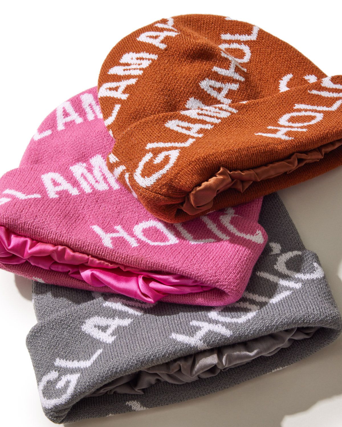 Cozy red monogram beanie featuring bold Glam-Aholic branding, perfect for stylish warmth in any season.