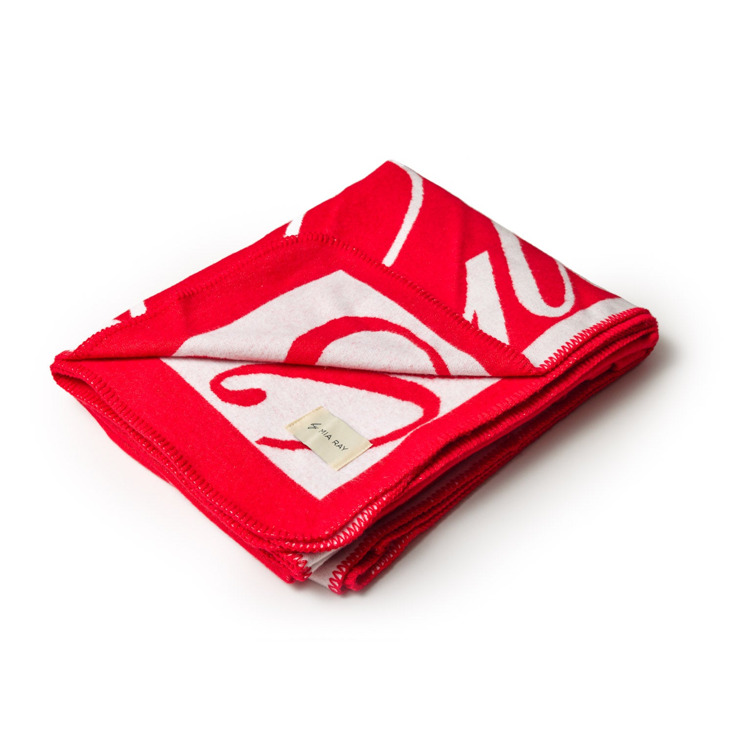 Red luxury throw blanket with a bold white logo design, folded neatly with a small fabric tag.
