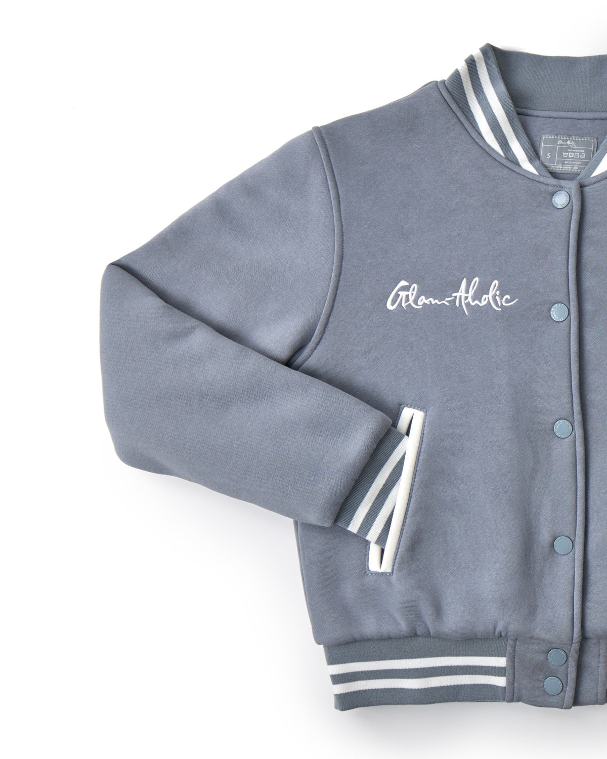 Gray varsity jacket with striped ribbed collar, cuffs, and waistband, featuring "Team Athletic" embroidery on the chest.