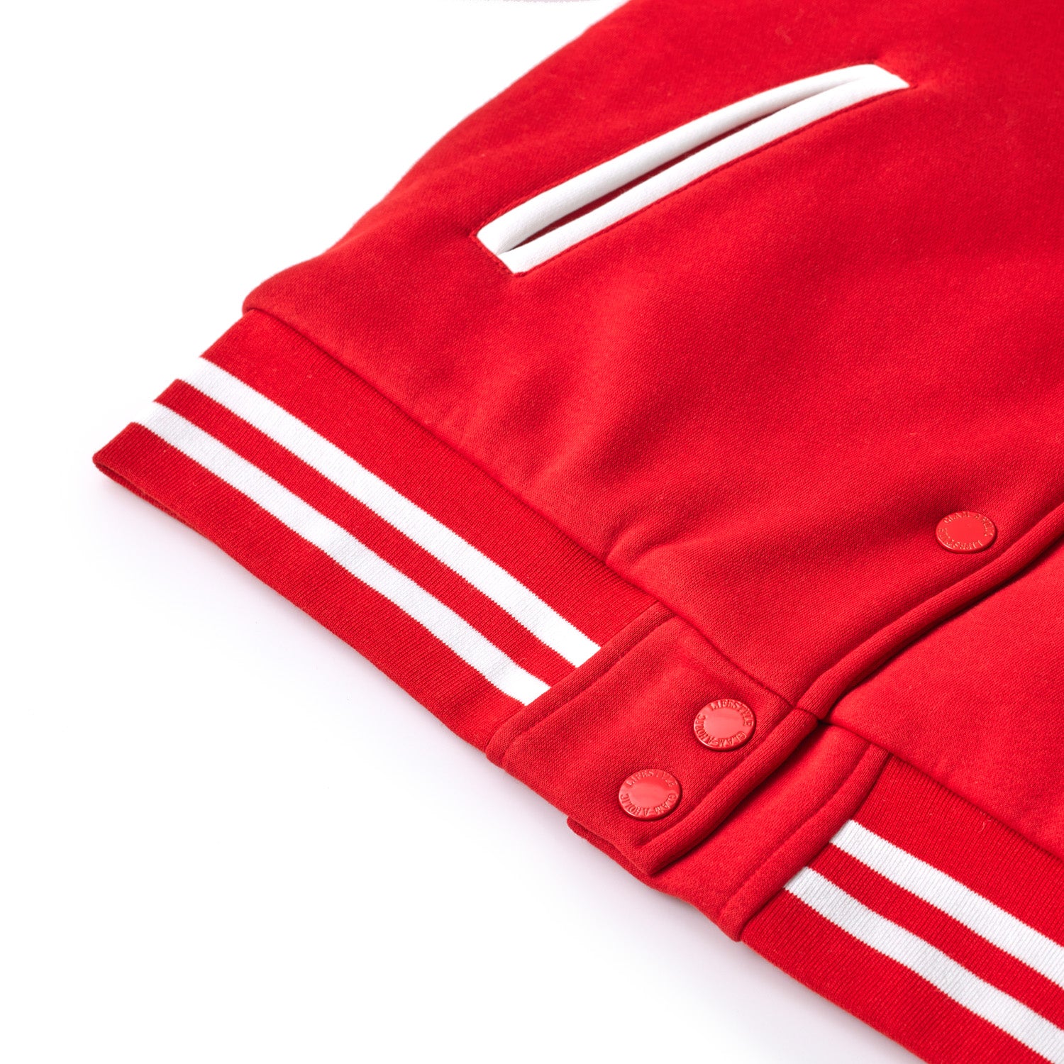 Red varsity jacket with white striped cuffs, snap buttons, and a white embroidered patch on the chest.