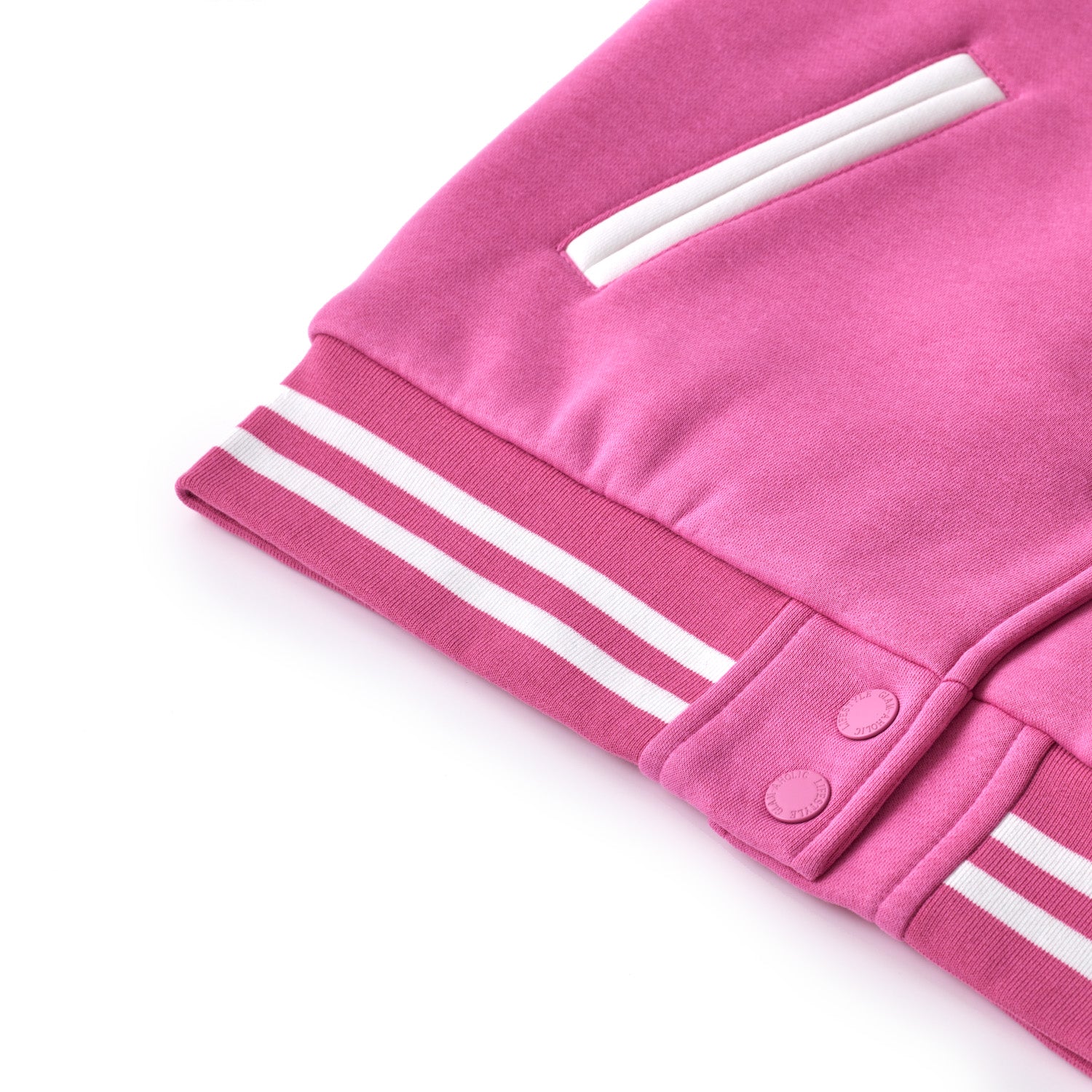 Close-up of a hot pink varsity jacket with white striped cuffs, snap buttons, and a white pocket detail.