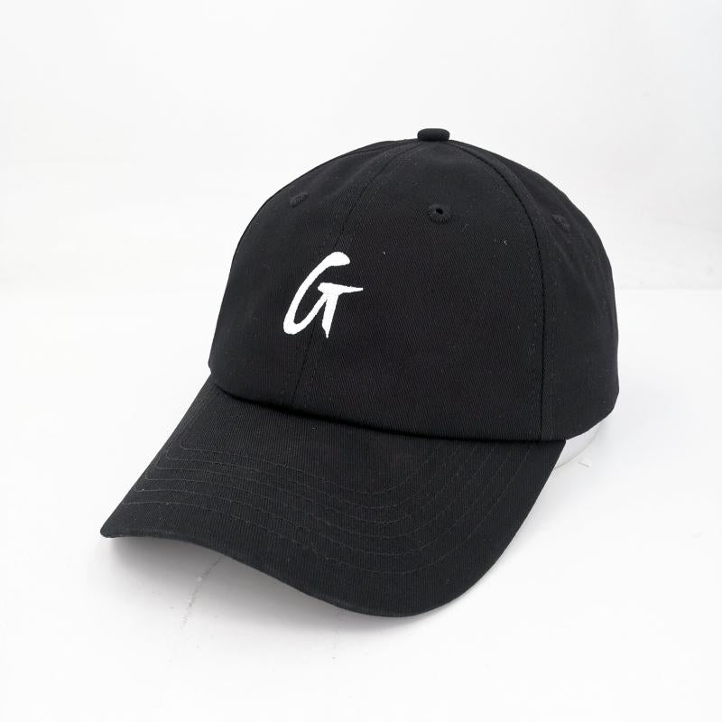 Black dad hat with a curved brim and white embroidered "GT" logo on the front. Adjustable strap for a custom fit.