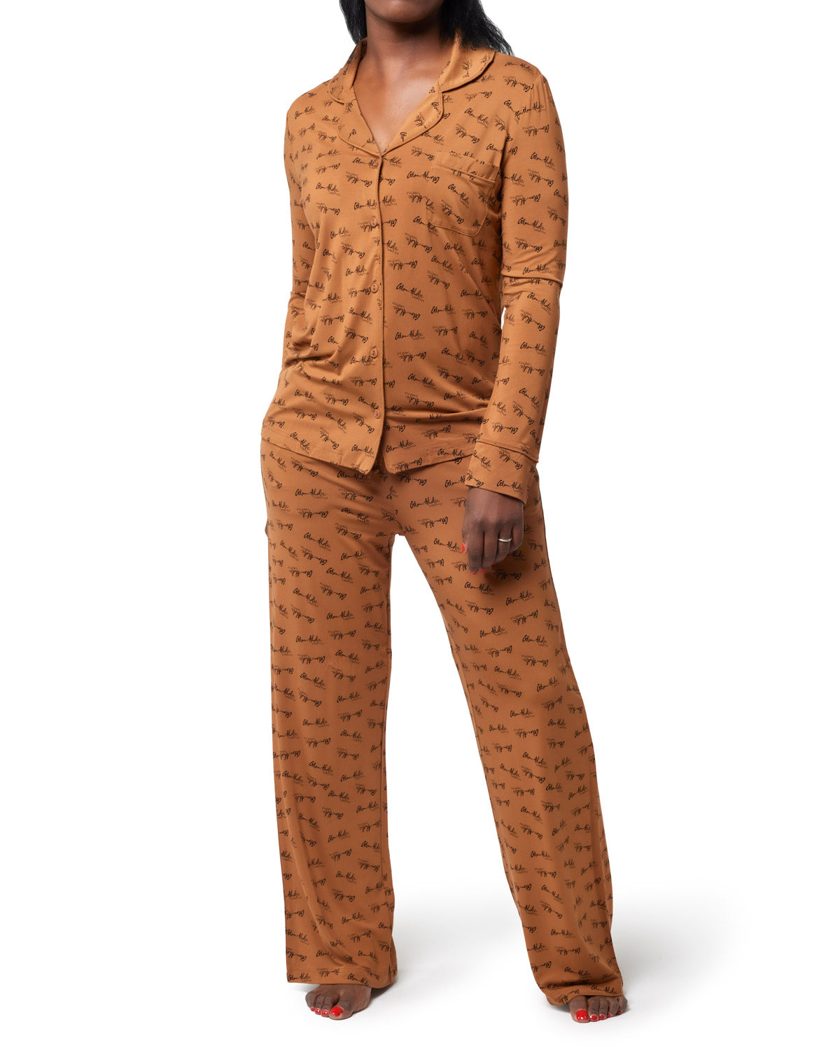 Brown signature pajamas set featuring a button-up top with pockets and matching pants, designed for comfort and style.