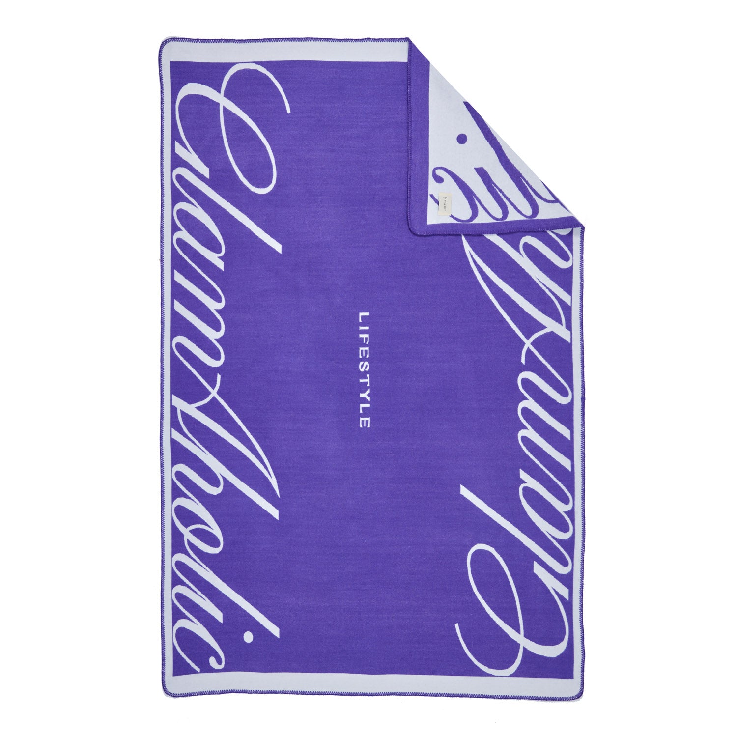 Luxurious purple throw blanket with white script design and "LIFESTYLE" text, featuring a soft, plush texture.
