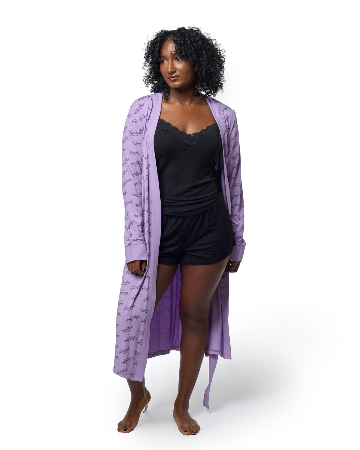 Lavender signature luxe robe worn over a black tank top and shorts, showcasing a stylish and comfortable look.